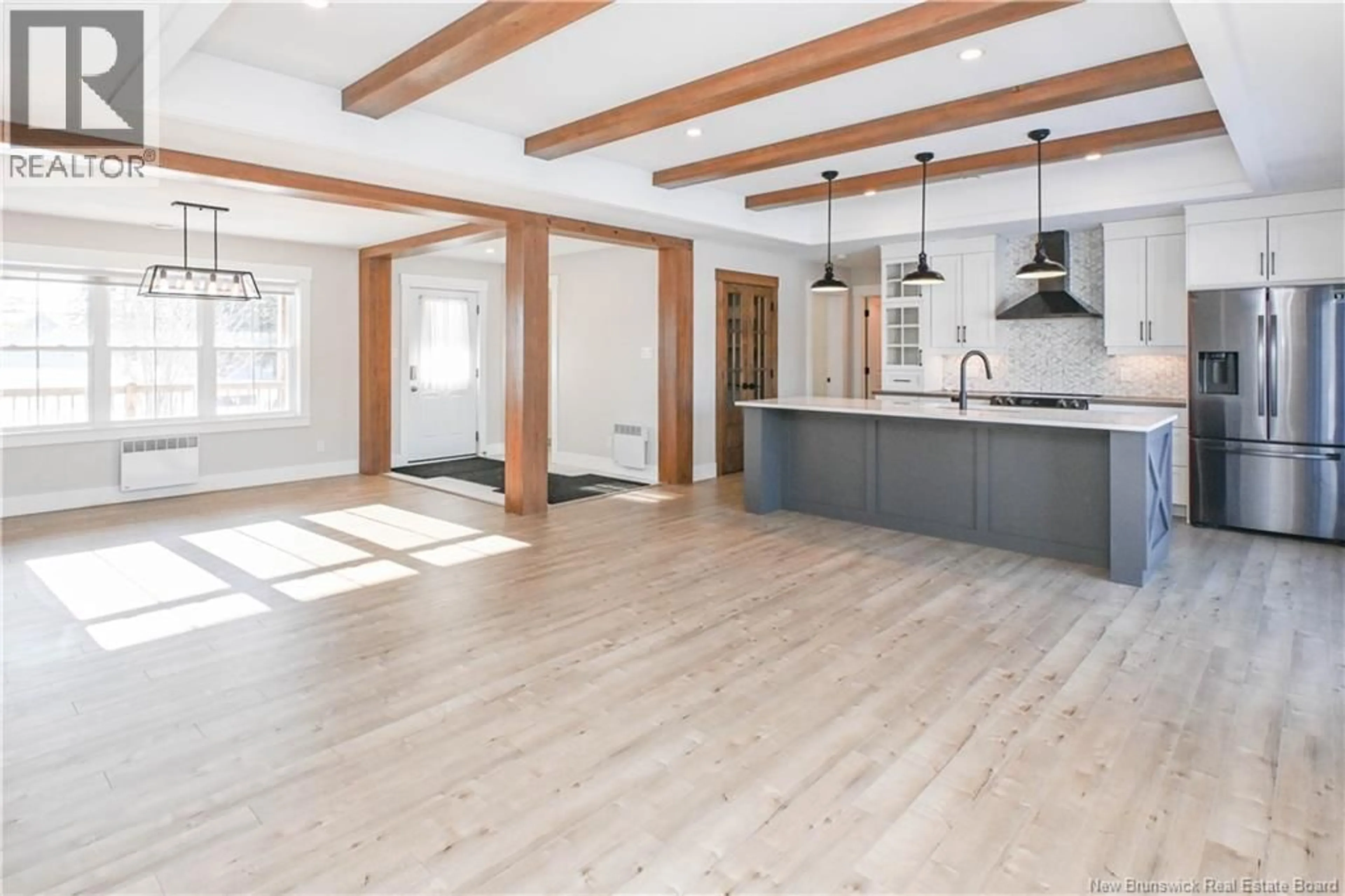 Open concept kitchen, wood/laminate floor for 4071 DES FONDATEURS BOULEVARD, Saint-Isidore New Brunswick E8M1G3