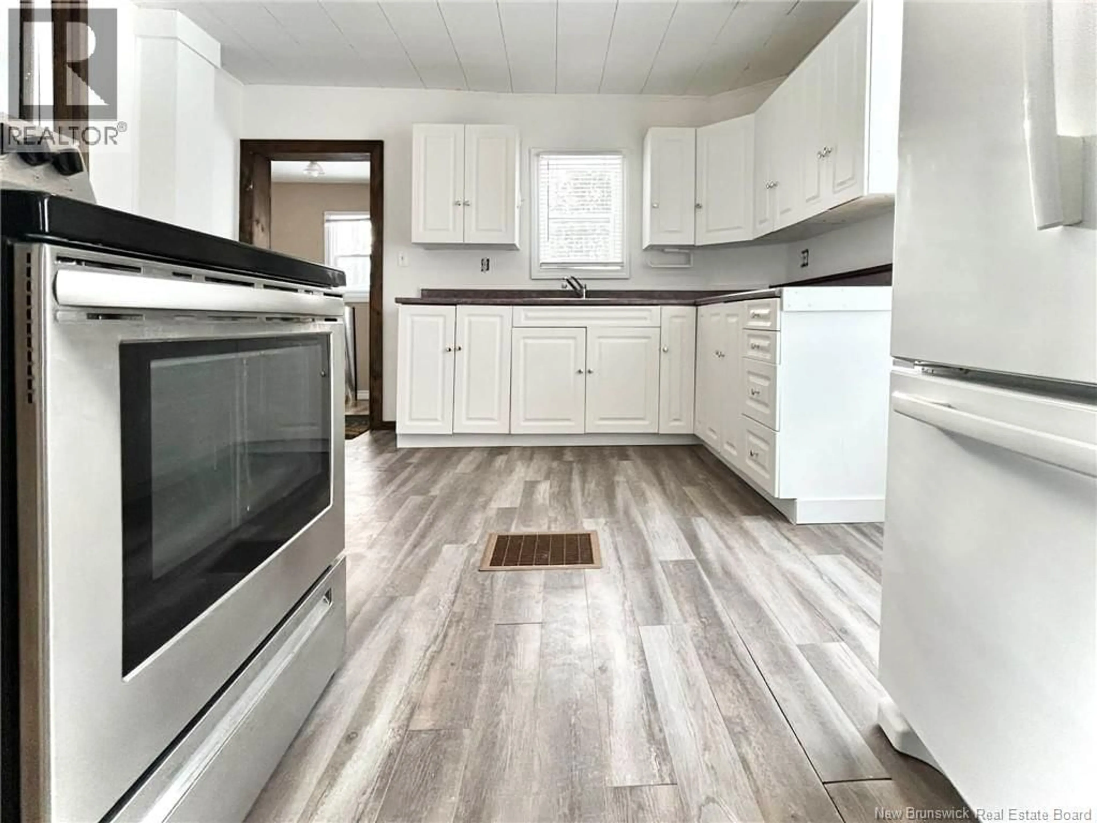 Open concept kitchen, wood/laminate floor for 16 HIGHFIELD STREET, Miramichi New Brunswick E1N4J3