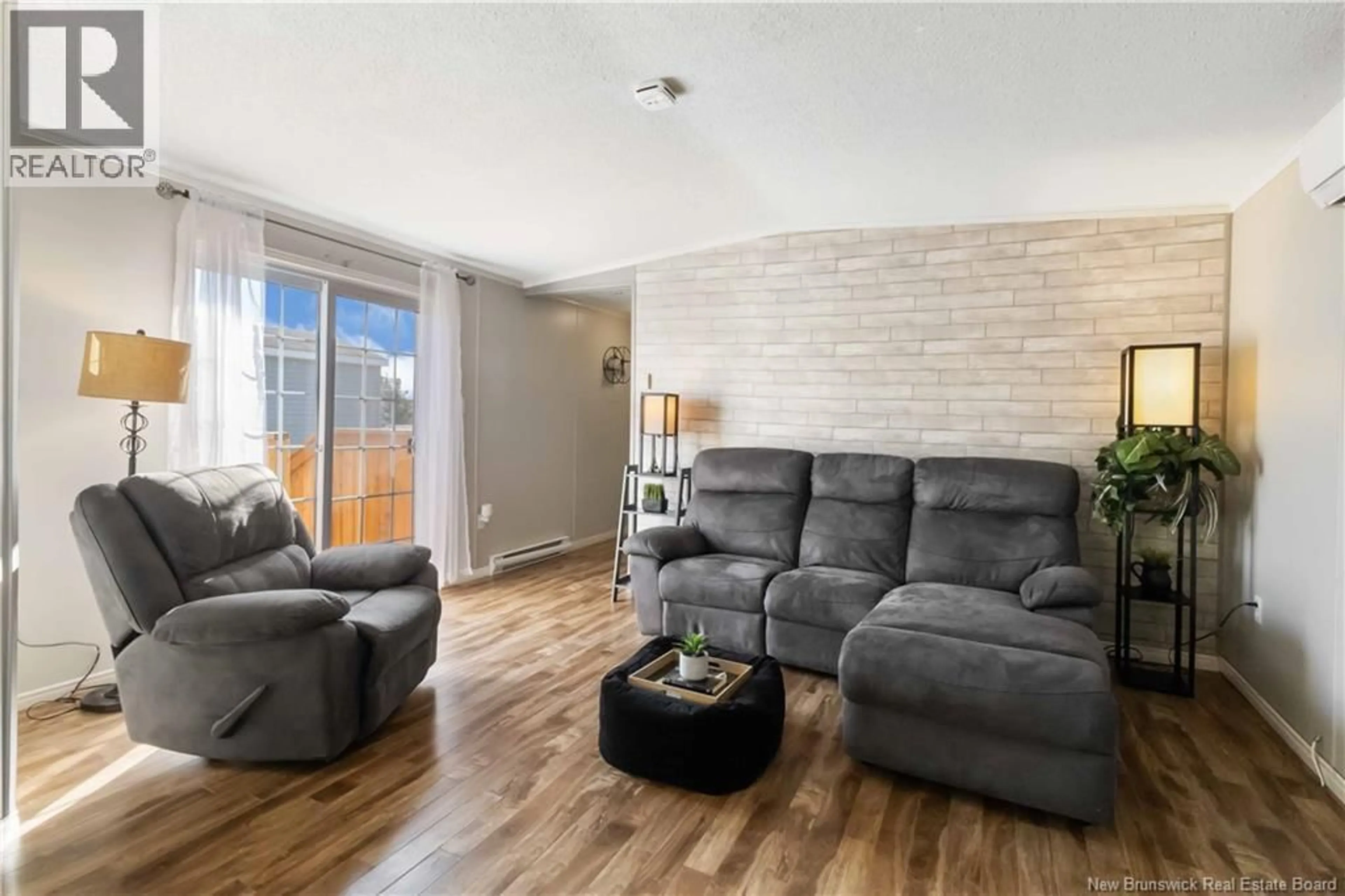 Living room with furniture, wood/laminate floor for 46 STE MARIE LANE, Dieppe New Brunswick E1A8W4