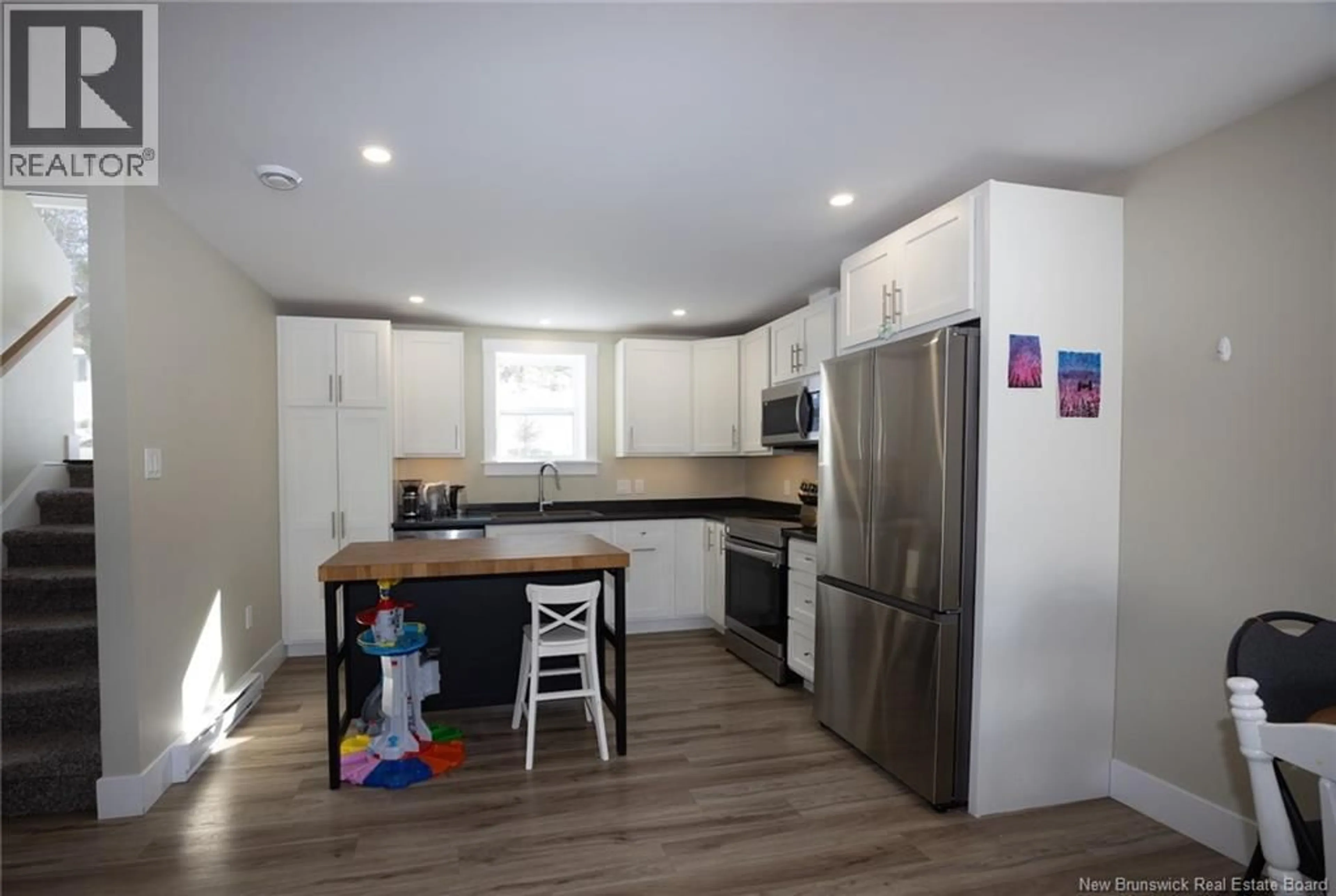 Open concept kitchen, wood/laminate floor for 67 DEWITT ACRES, Fredericton New Brunswick E3A6S3