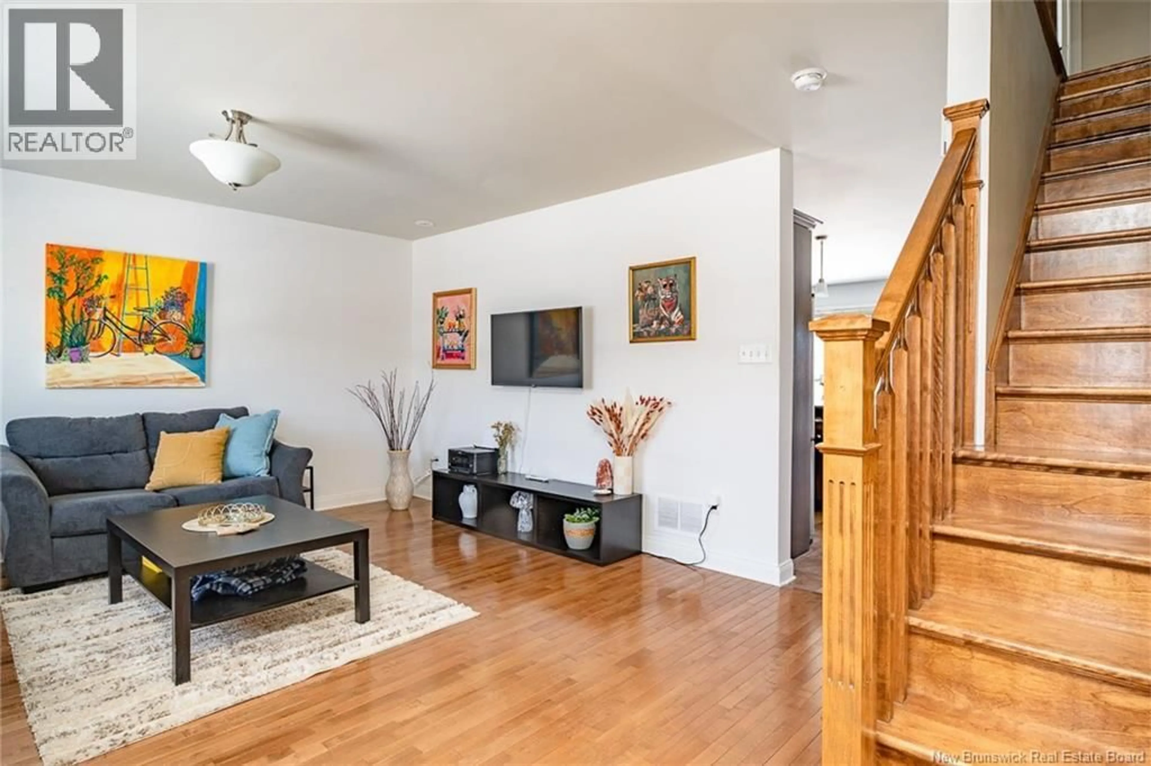 Living room with furniture, wood/laminate floor for 24 WESTIN LANE, Fredericton New Brunswick E3A5X2