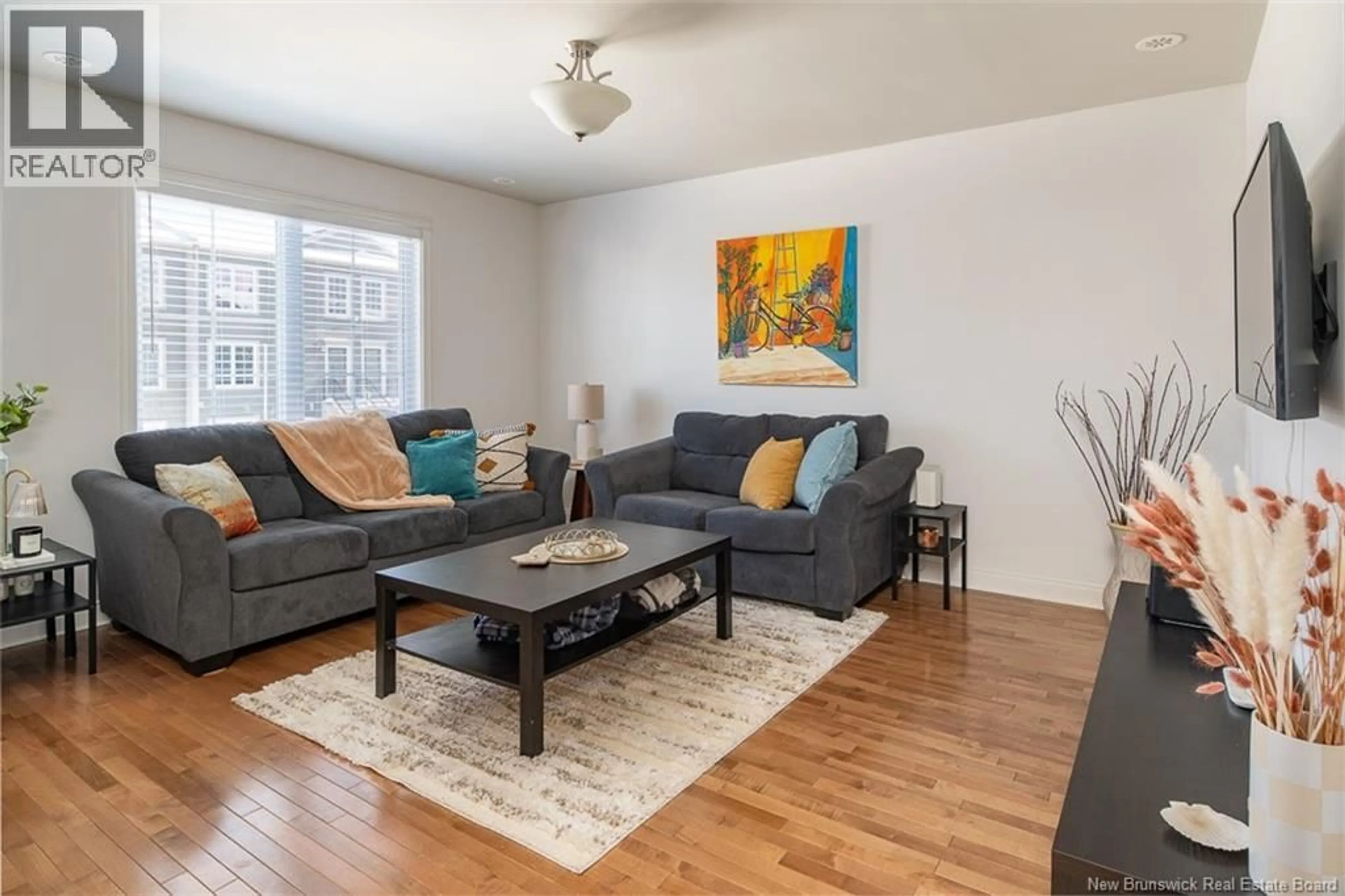 Living room with furniture, wood/laminate floor for 24 WESTIN LANE, Fredericton New Brunswick E3A5X2
