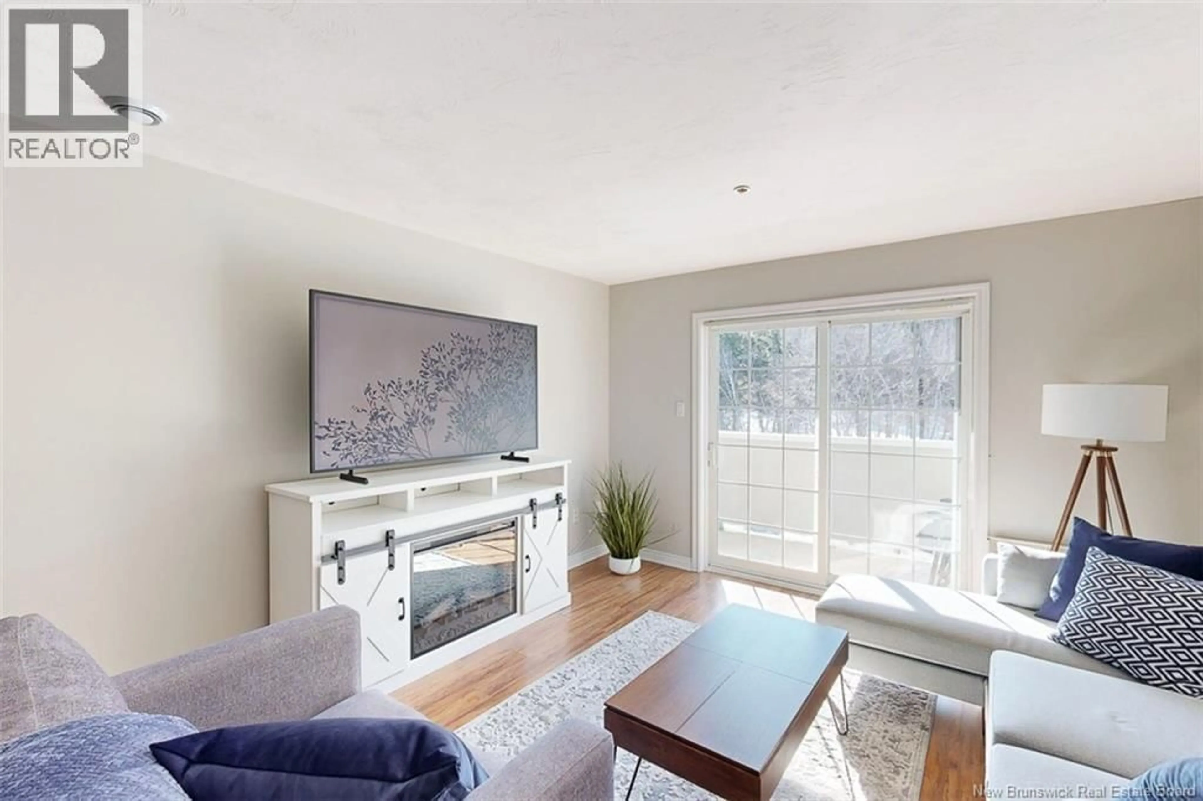 Living room with furniture, wood/laminate floor for 410 - 158 HANWELL ROAD, Fredericton New Brunswick E3B9K7