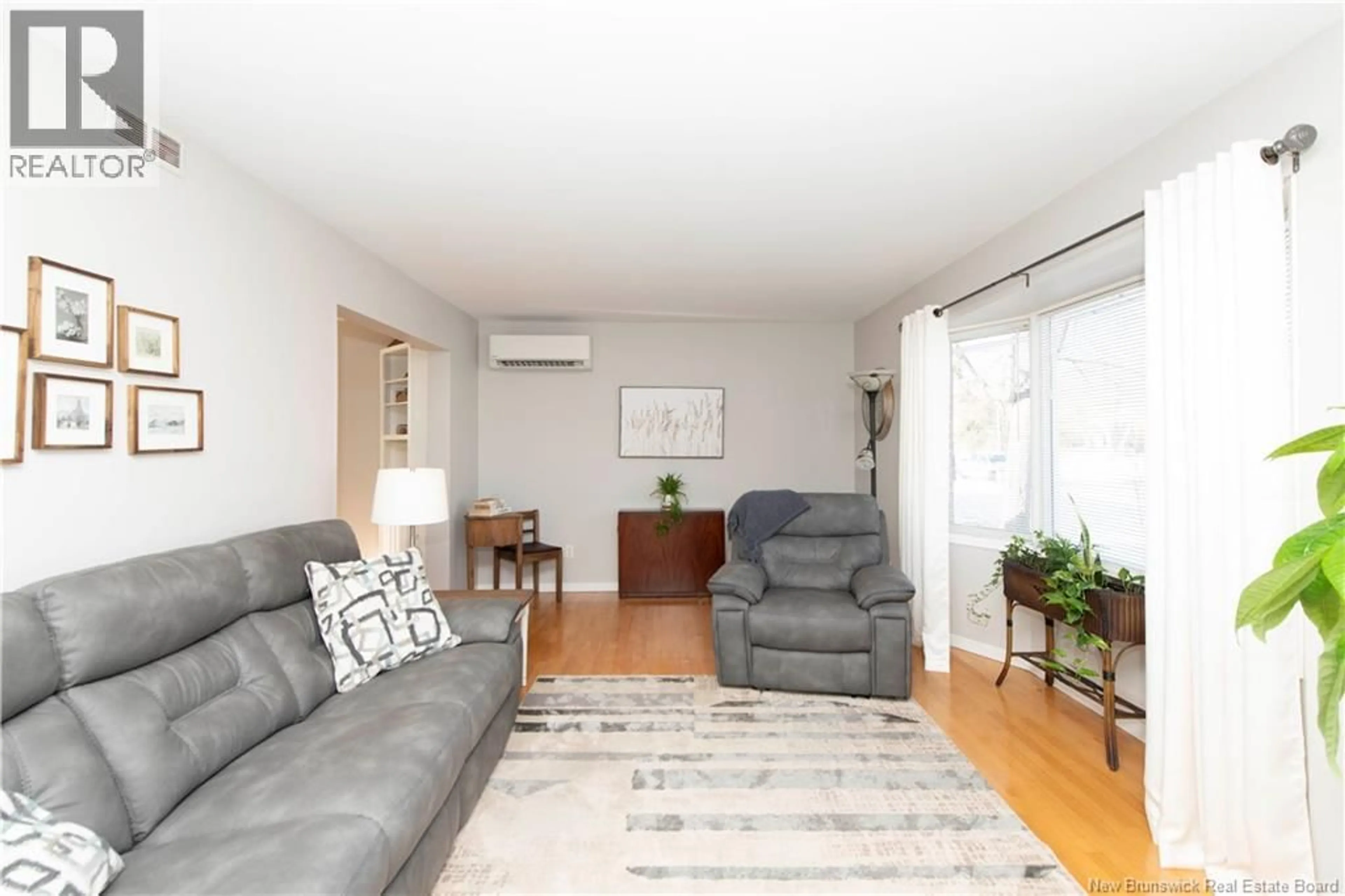 Living room with furniture, wood/laminate floor for 82 CRESTWOOD DRIVE, Moncton New Brunswick E1C9E4