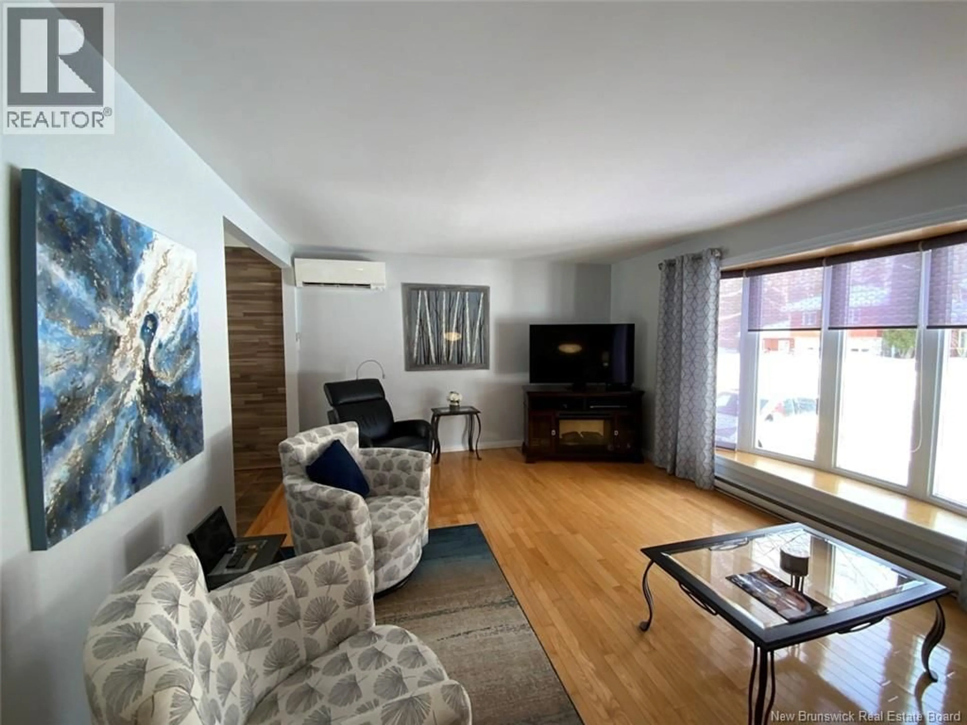 Living room with furniture, wood/laminate floor for 49 HUBERT STREET, Edmundston New Brunswick E3V4K6