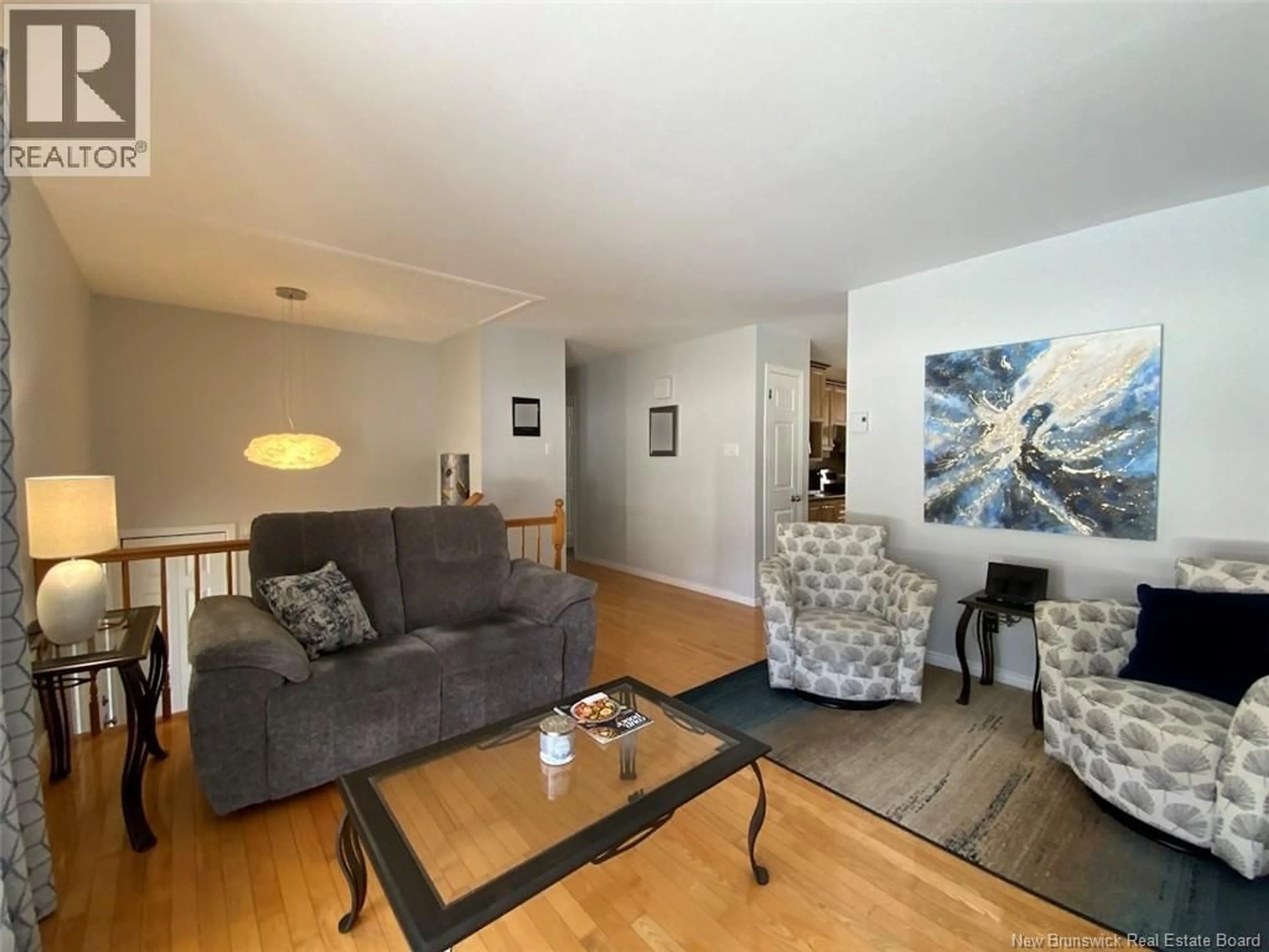 Living room with furniture, wood/laminate floor for 49 HUBERT STREET, Edmundston New Brunswick E3V4K6