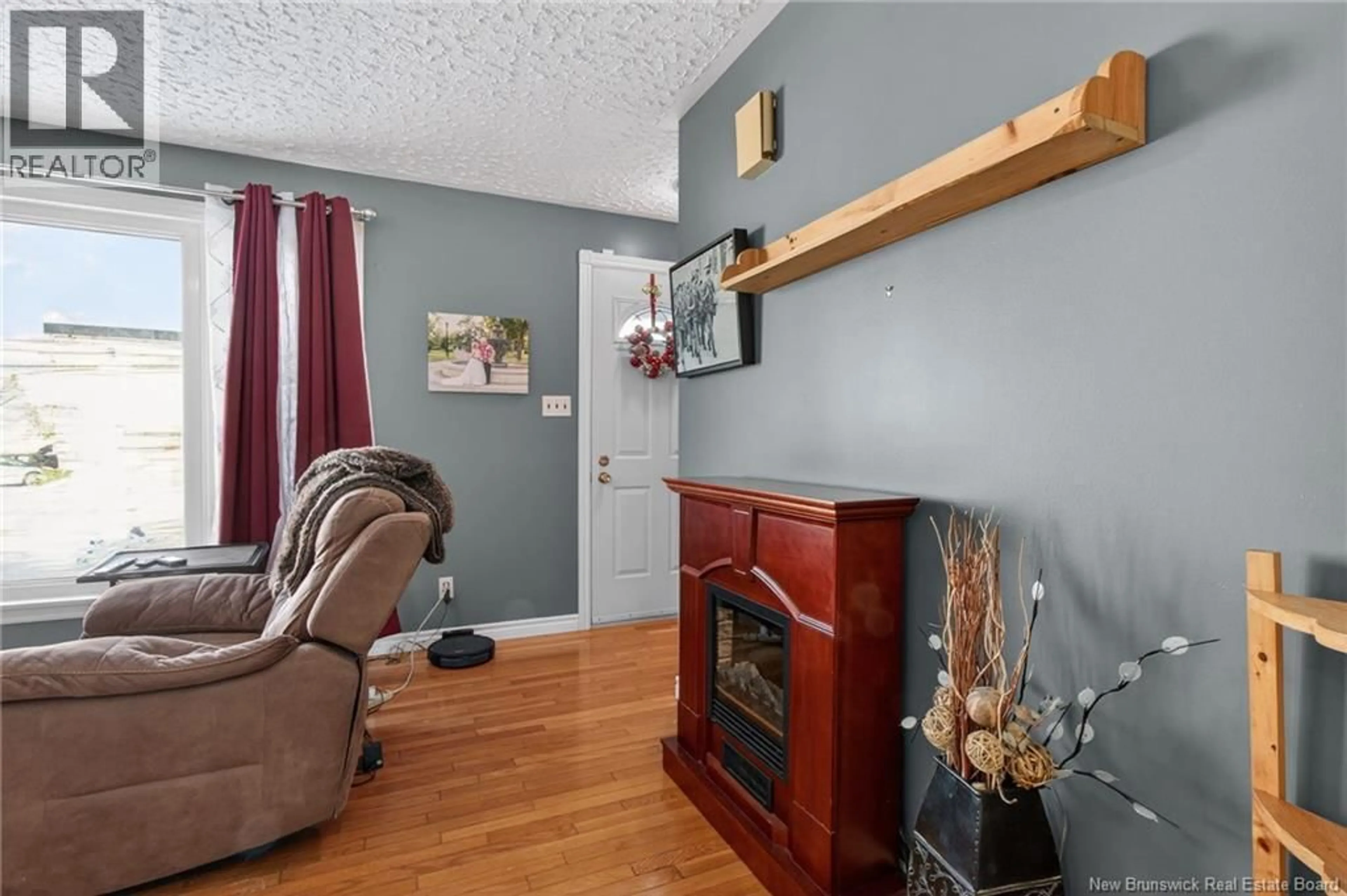 Living room with furniture, wood/laminate floor for 124 REDMOND ST, Moncton New Brunswick E1A3J7