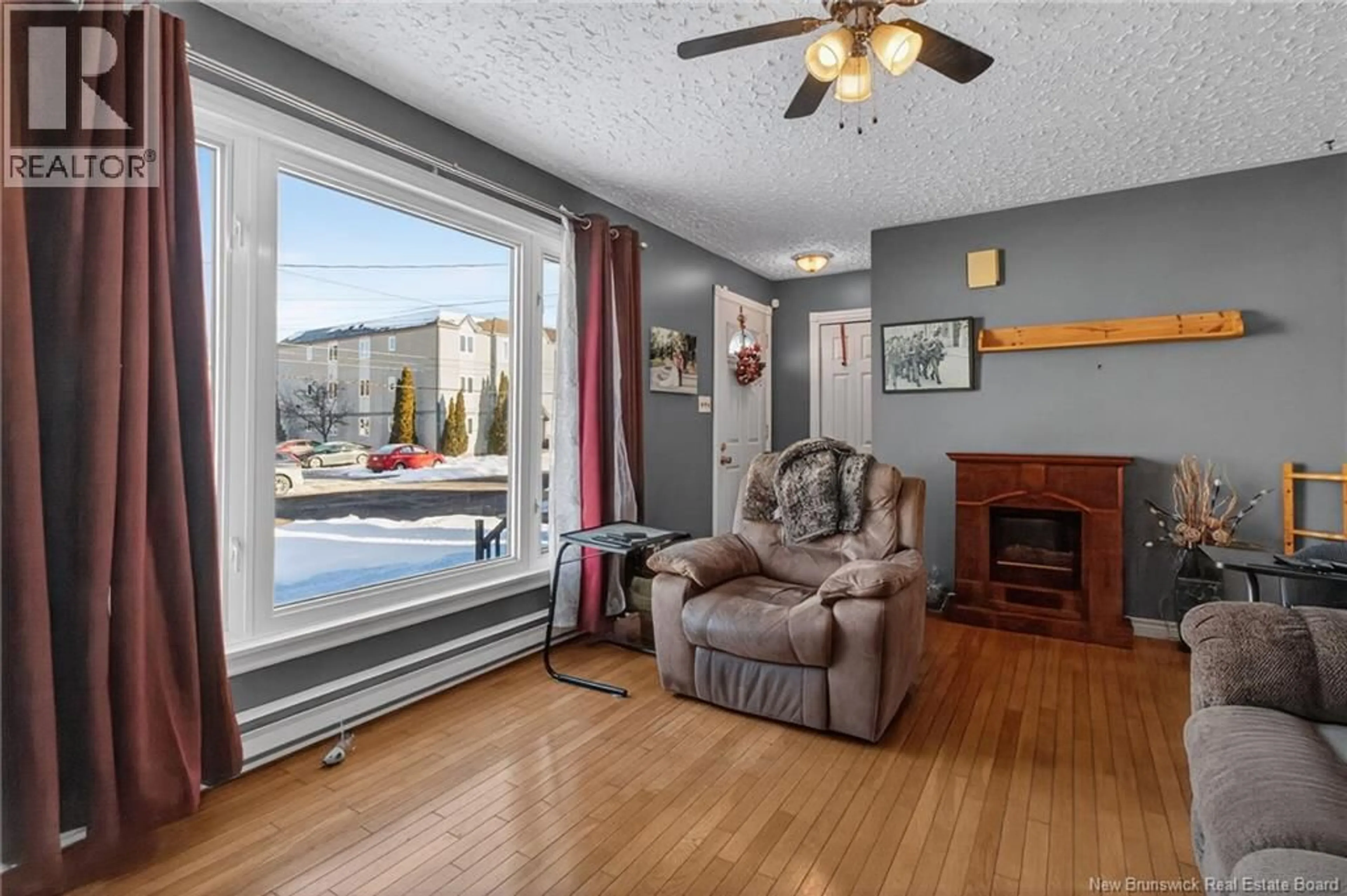 Living room with furniture, wood/laminate floor for 124 REDMOND ST, Moncton New Brunswick E1A3J7