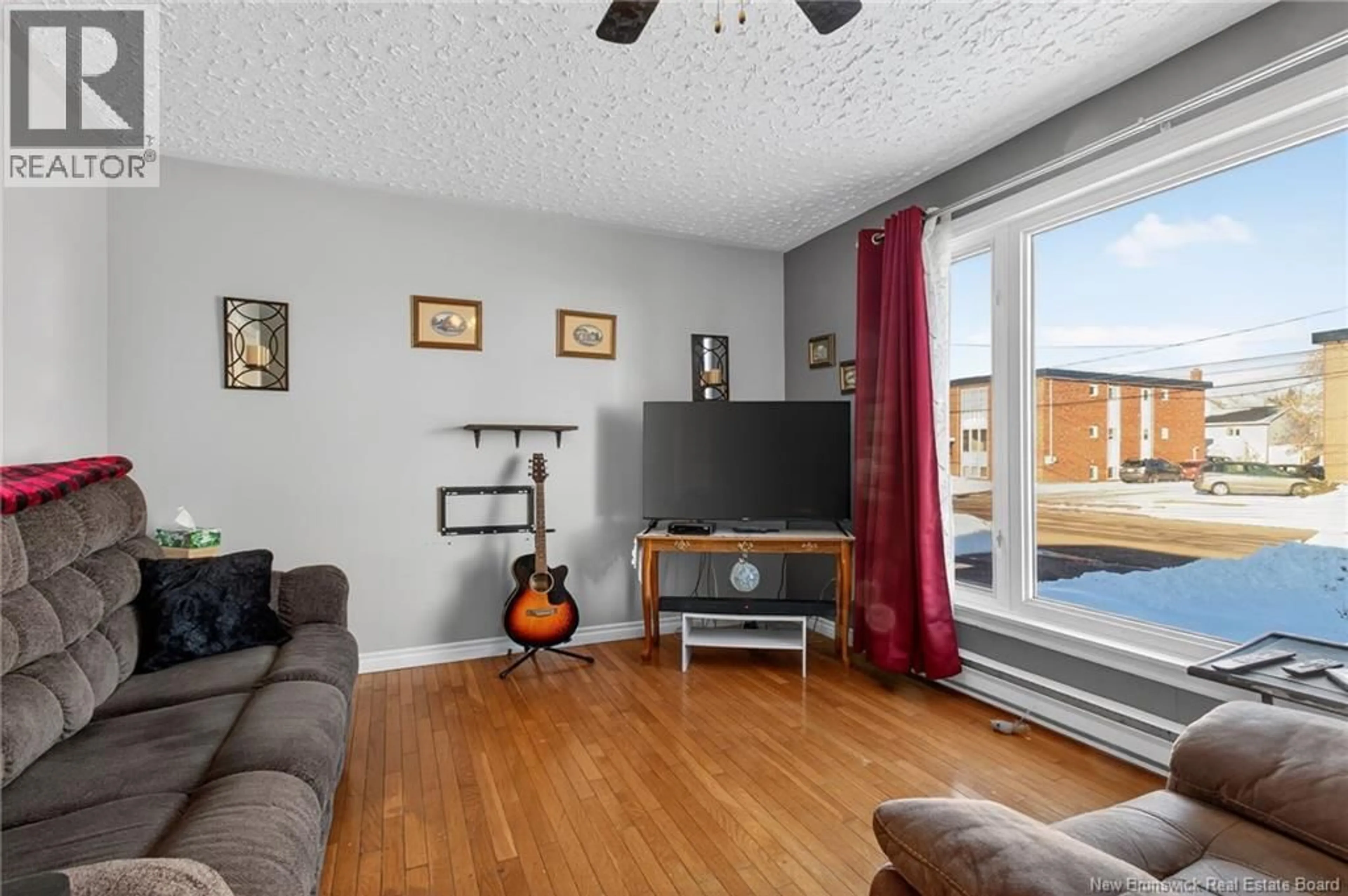 Living room with furniture, wood/laminate floor for 124 REDMOND ST, Moncton New Brunswick E1A3J7