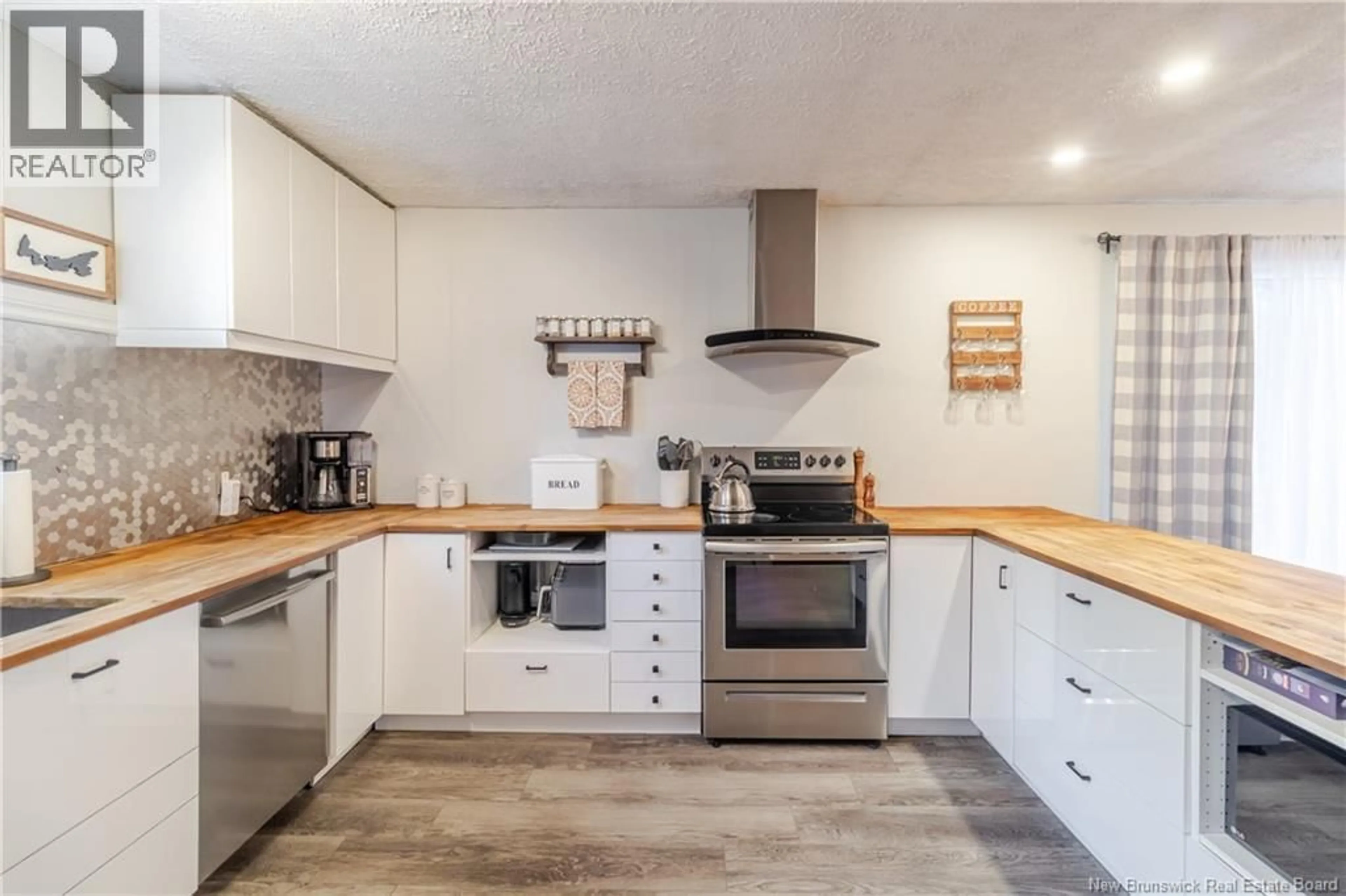 Open concept kitchen, wood/laminate floor for 3 MITCHELL COURT, Waasis New Brunswick E3B8V1