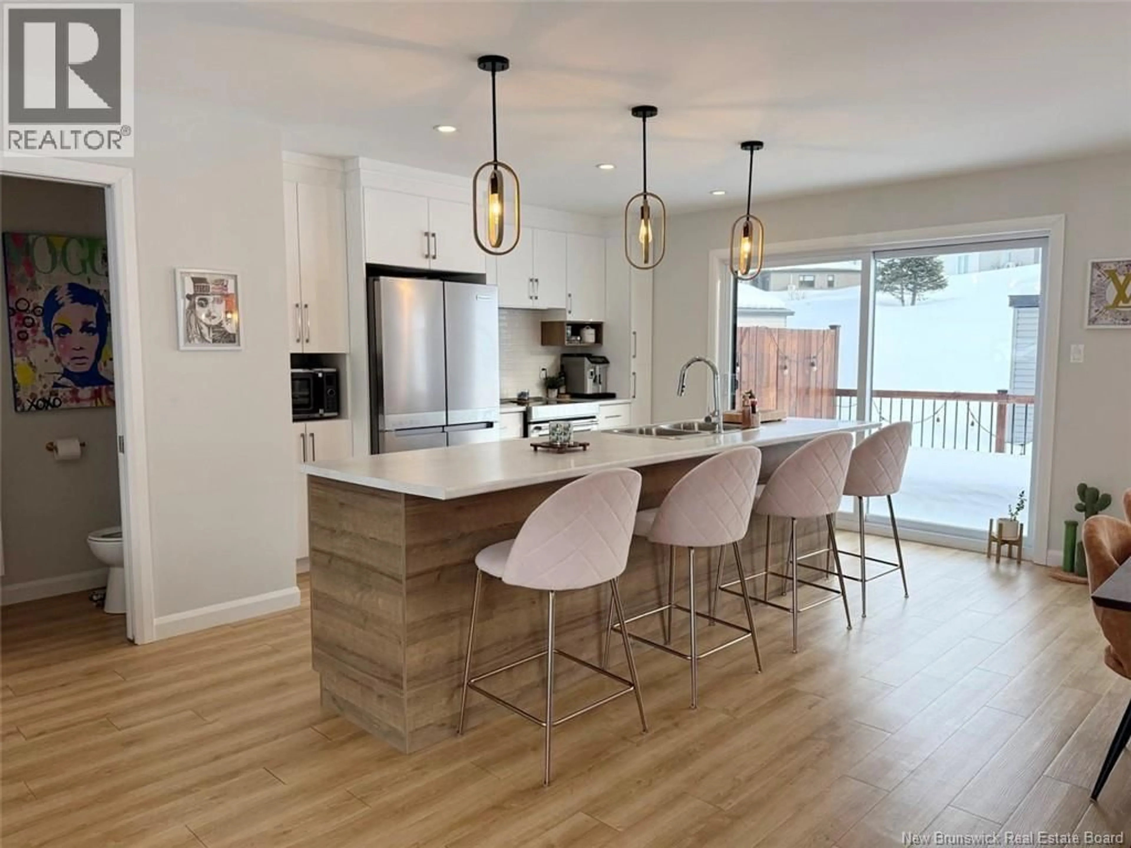 Open concept kitchen, wood/laminate floor for 44 VOLPÉ STREET, Edmundston New Brunswick E3V4A1