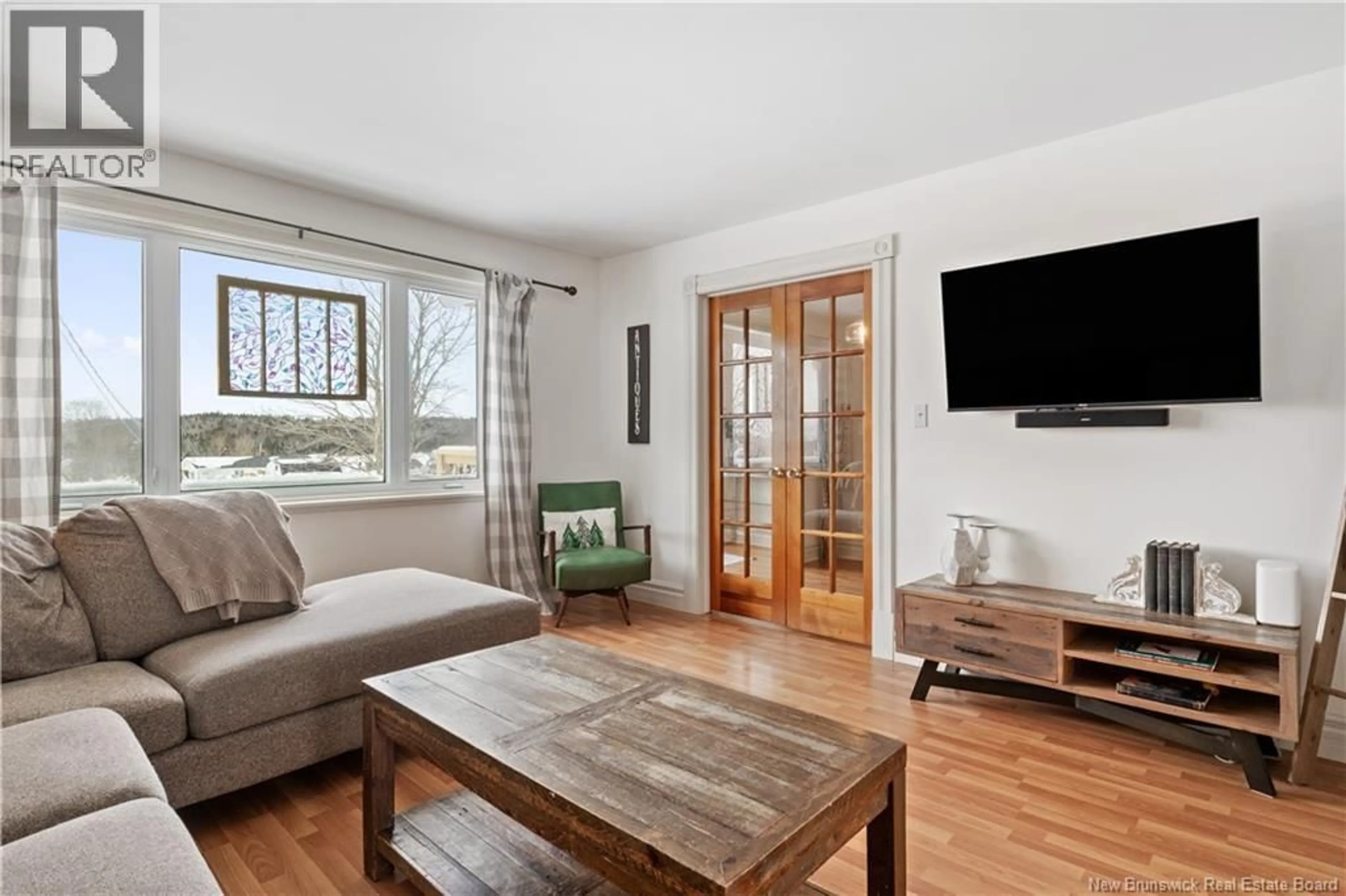 Living room with furniture, wood/laminate floor for 713 MEMRAMCOOK EAST, Memramcook New Brunswick E4K1L8