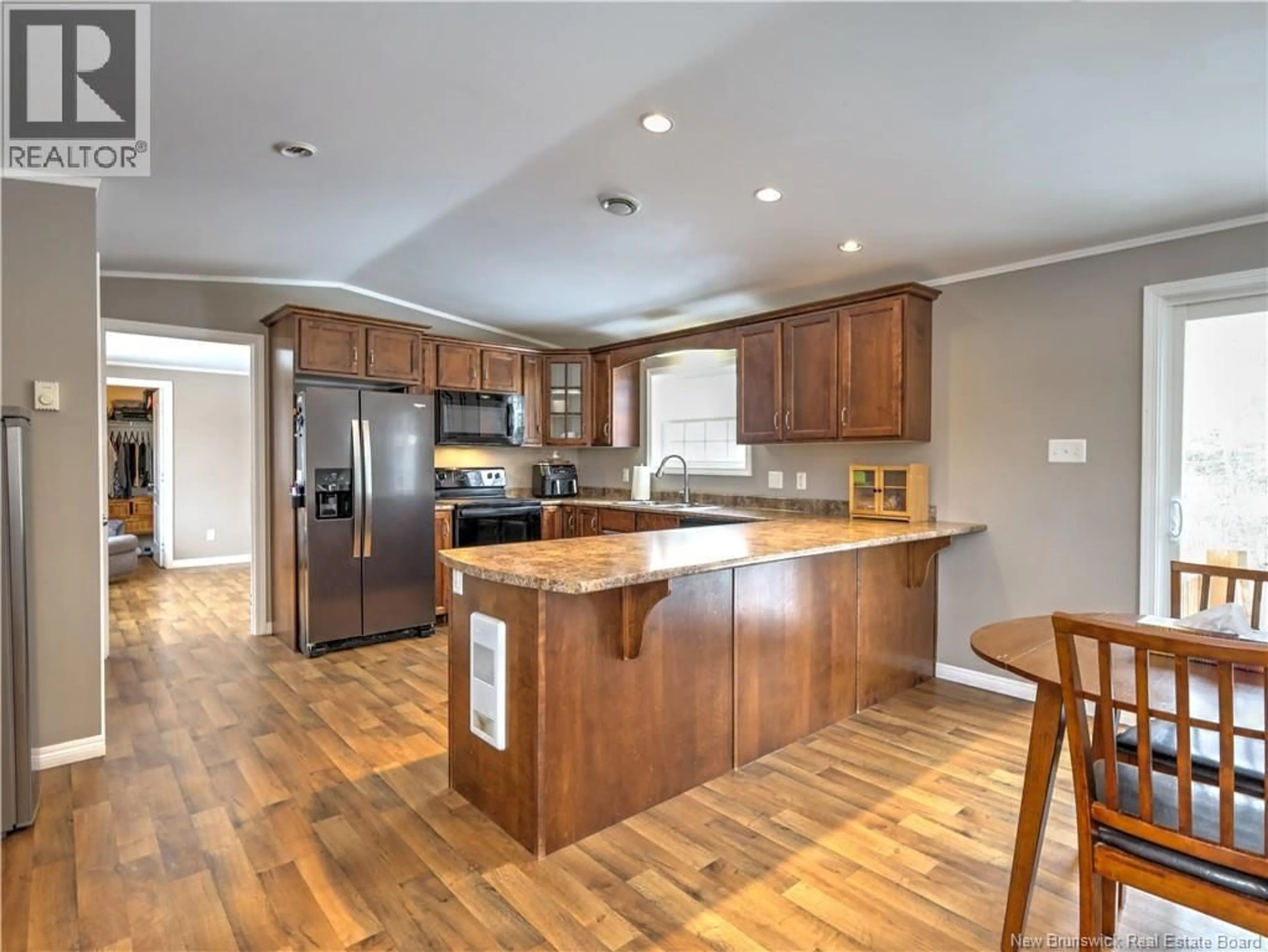 Open concept kitchen, wood/laminate floor for 16 CAROLYN STREET, Rusagonis New Brunswick E3B0W4