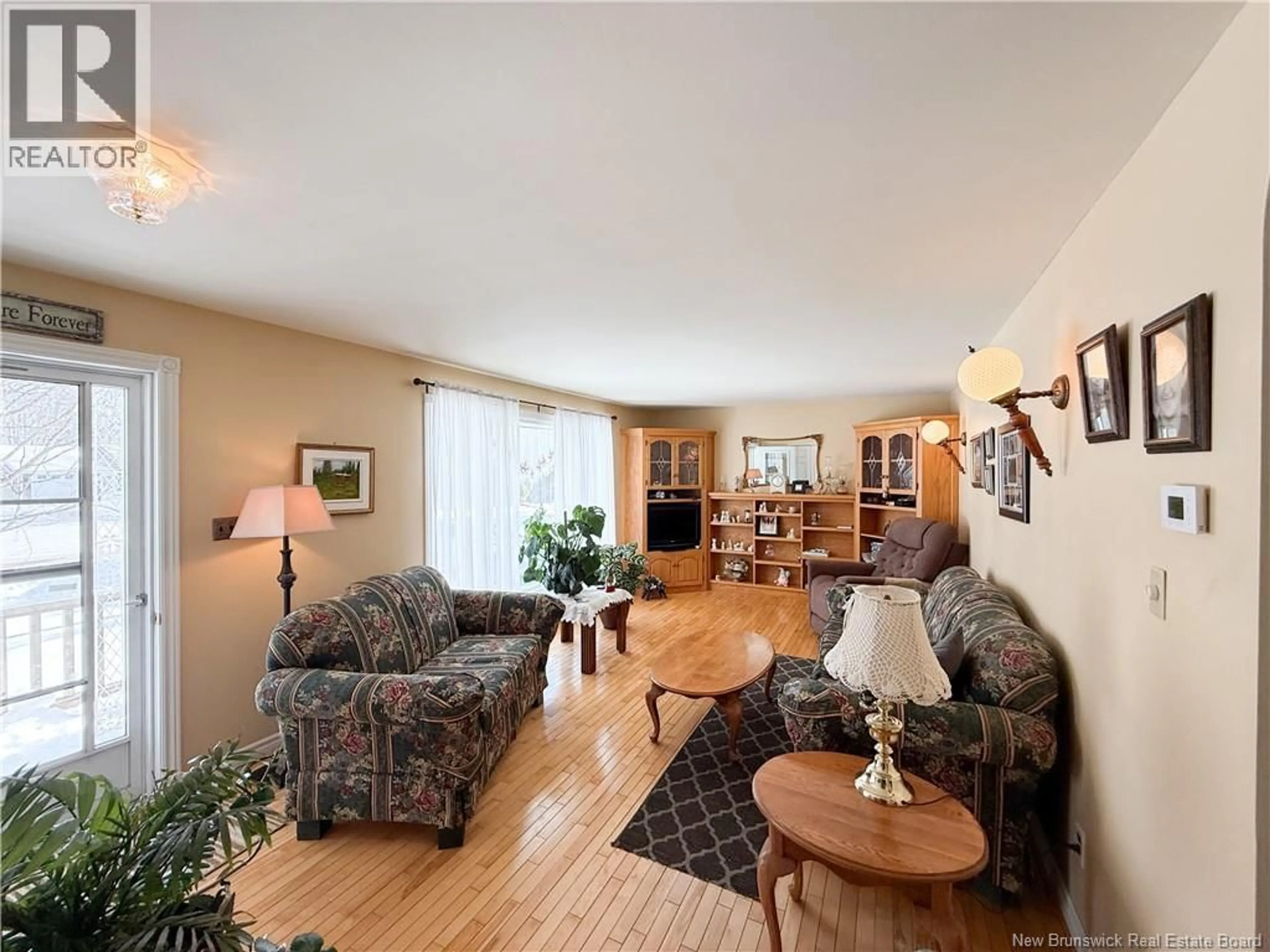 Living room with furniture, wood/laminate floor for 47 WILDWOOD CRESCENT, Roachville New Brunswick E4G2K6