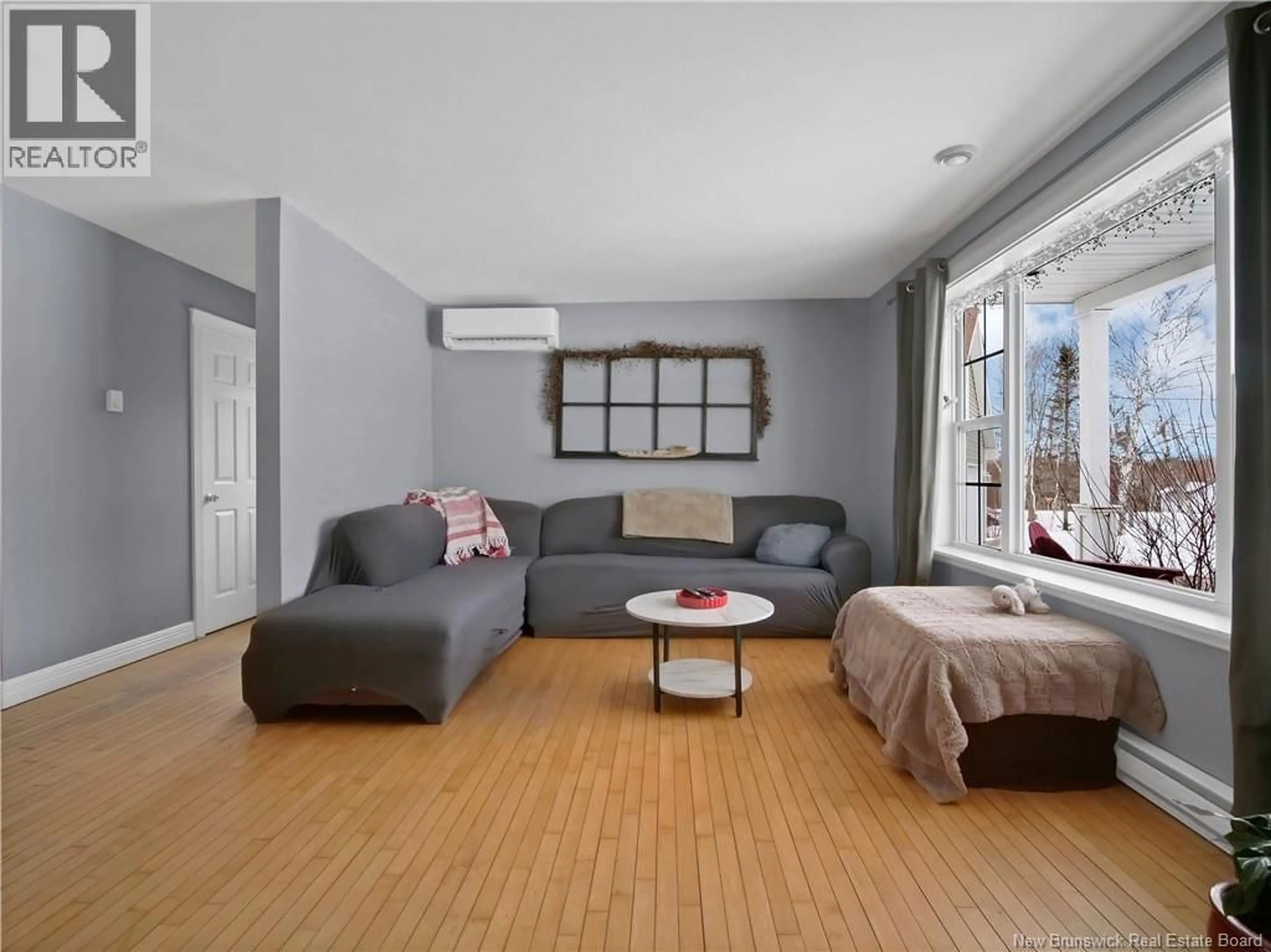 Living room with furniture, wood/laminate floor for 10 TALL PINE STREET, Irishtown New Brunswick E1H2K7