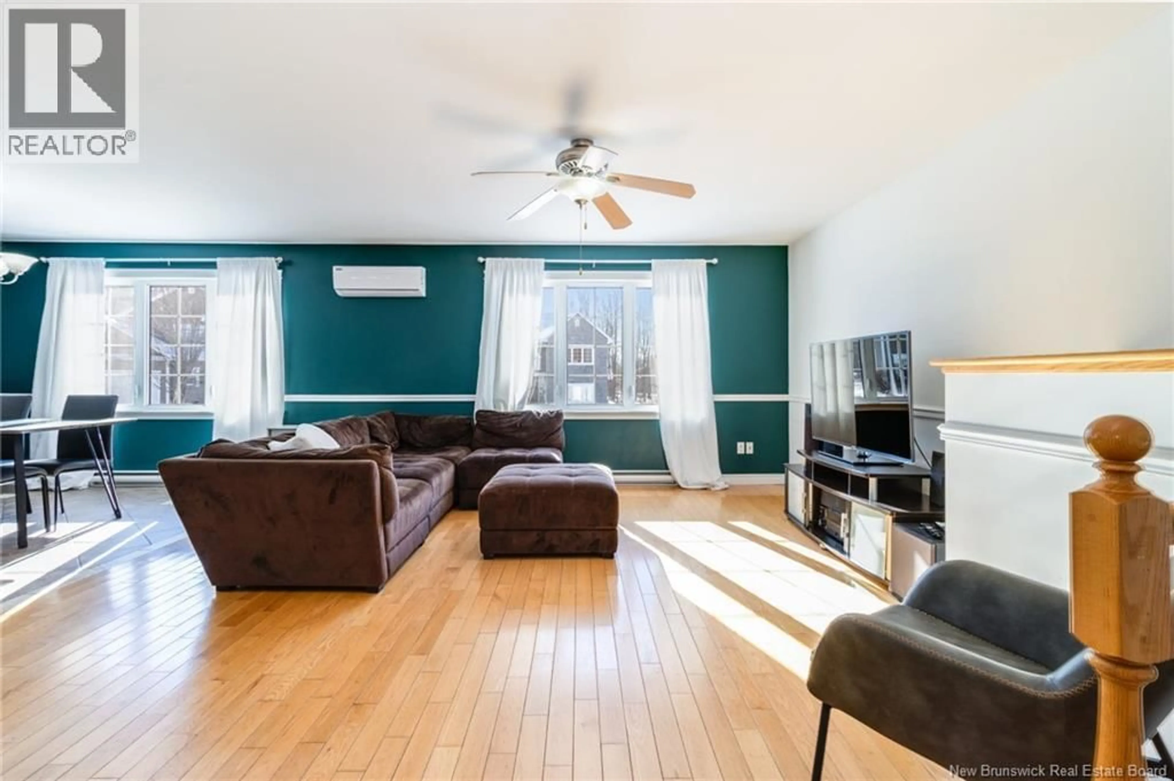 Living room with furniture, wood/laminate floor for 21 CARTER CRESCENT, Oromocto New Brunswick E2V0C4