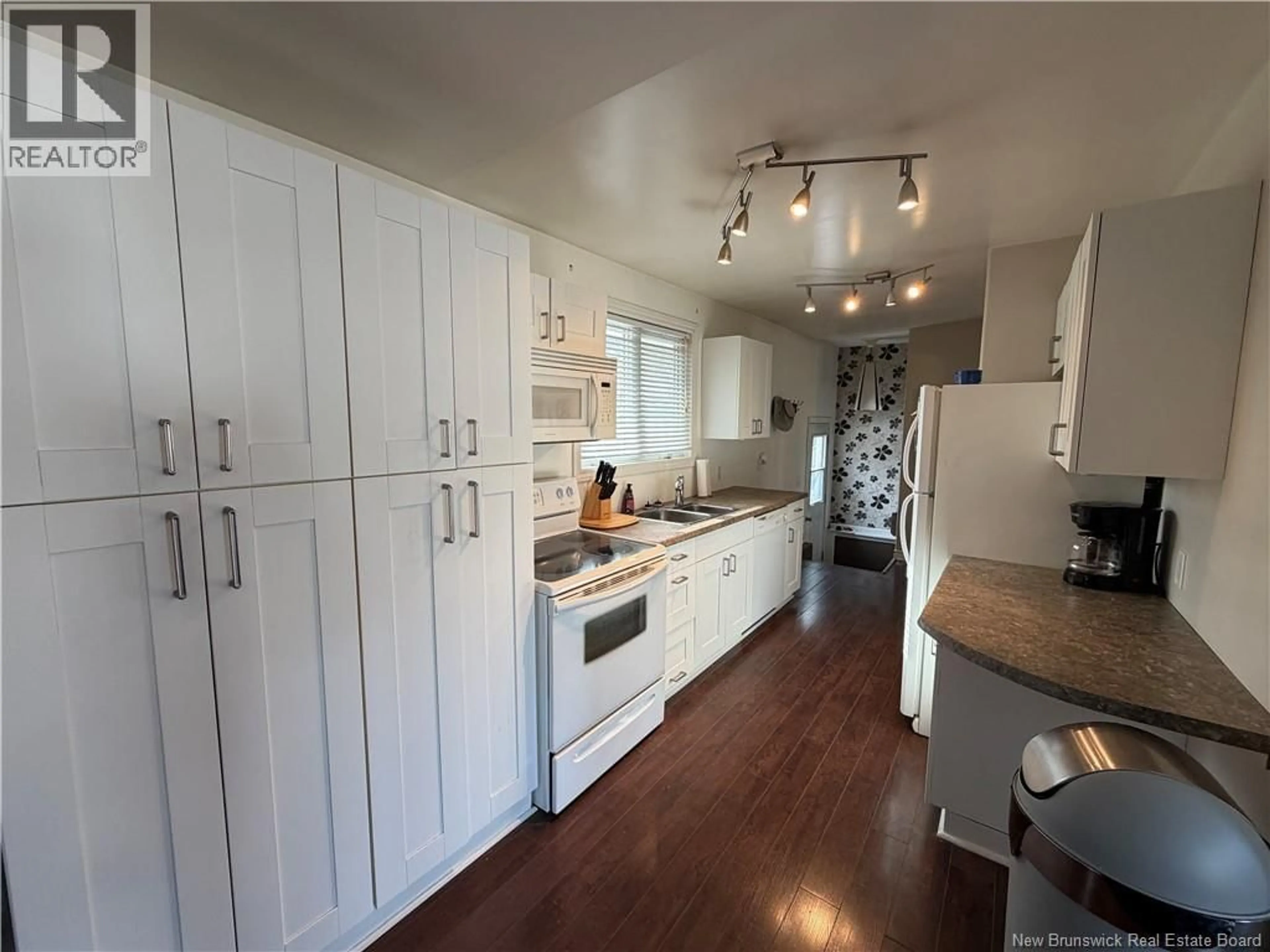Open concept kitchen, wood/laminate floor for 319 MCKAY STREET, Miramichi New Brunswick E1V2C2