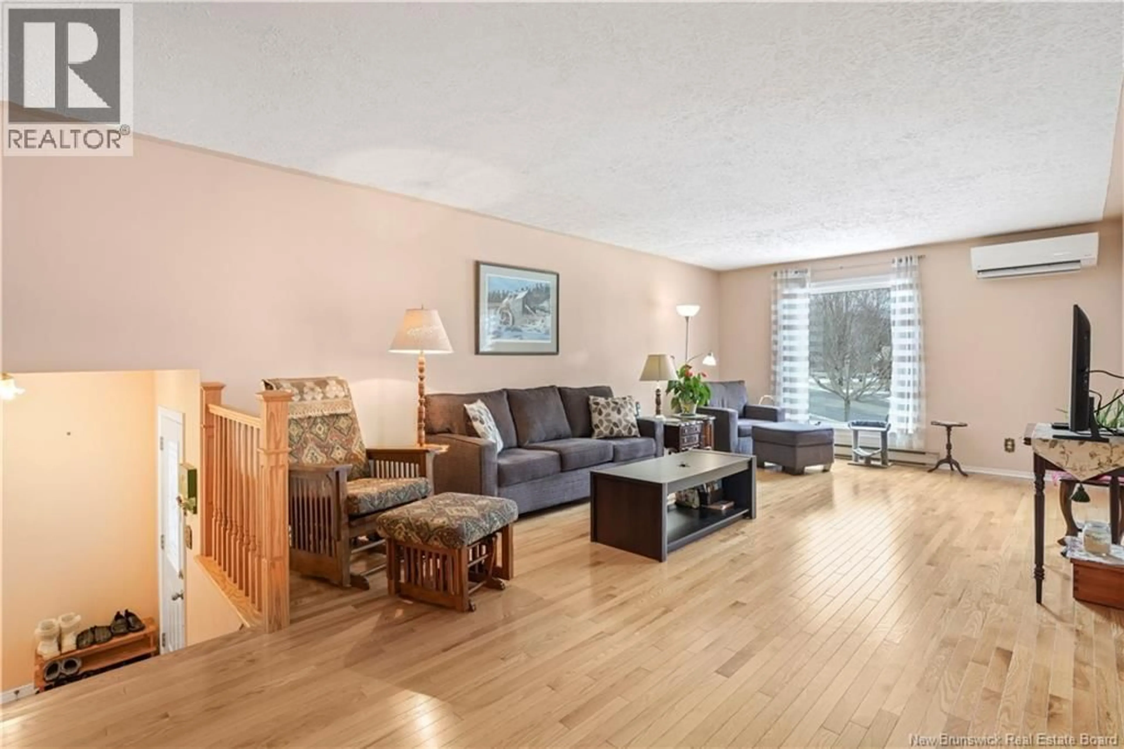 Living room with furniture, wood/laminate floor for 34 HURON AVENUE, Fredericton New Brunswick E3A1J7
