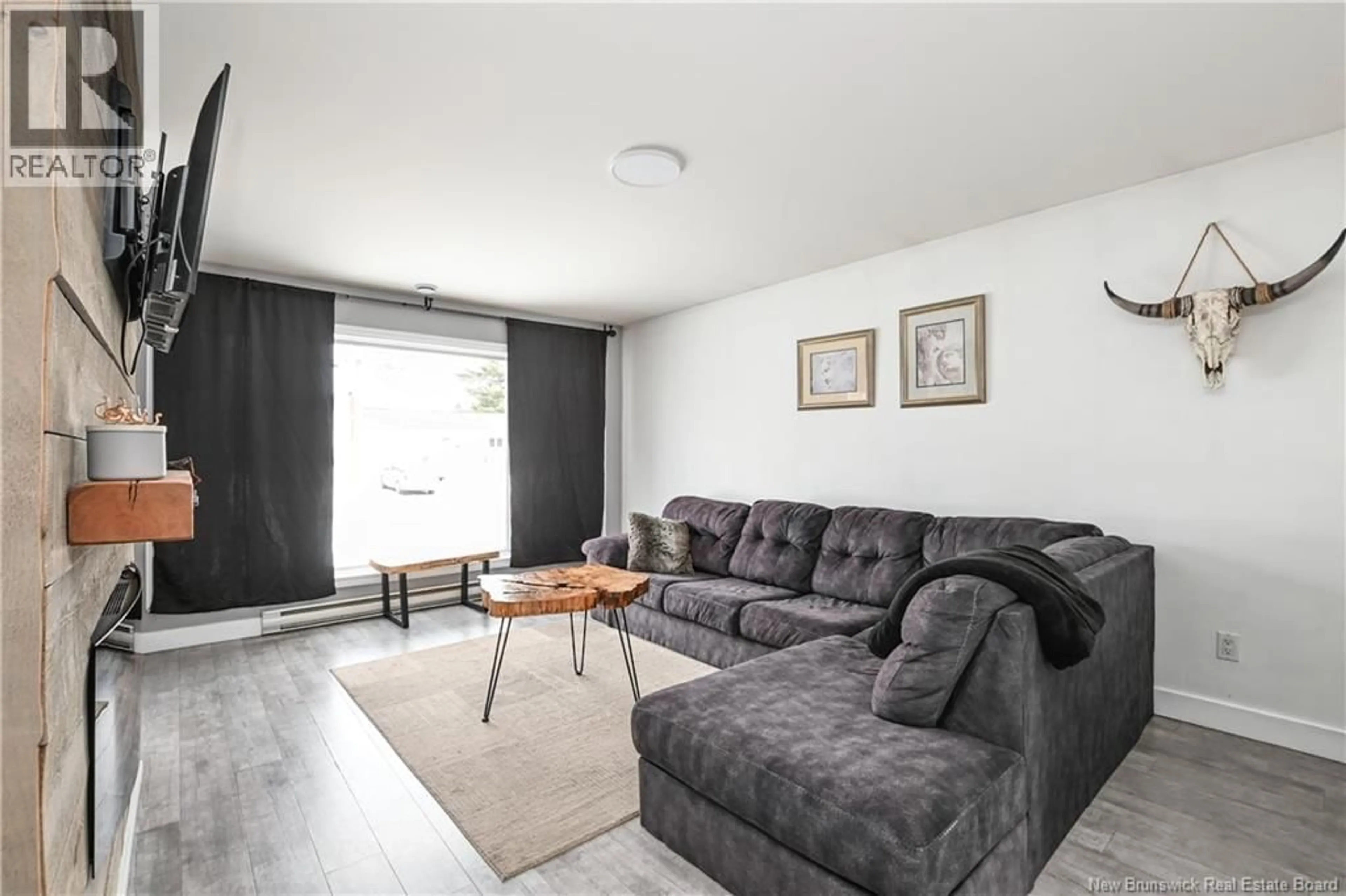 Living room with furniture, wood/laminate floor for 22 JORDAN CRESCENT, Moncton New Brunswick E1C0S6