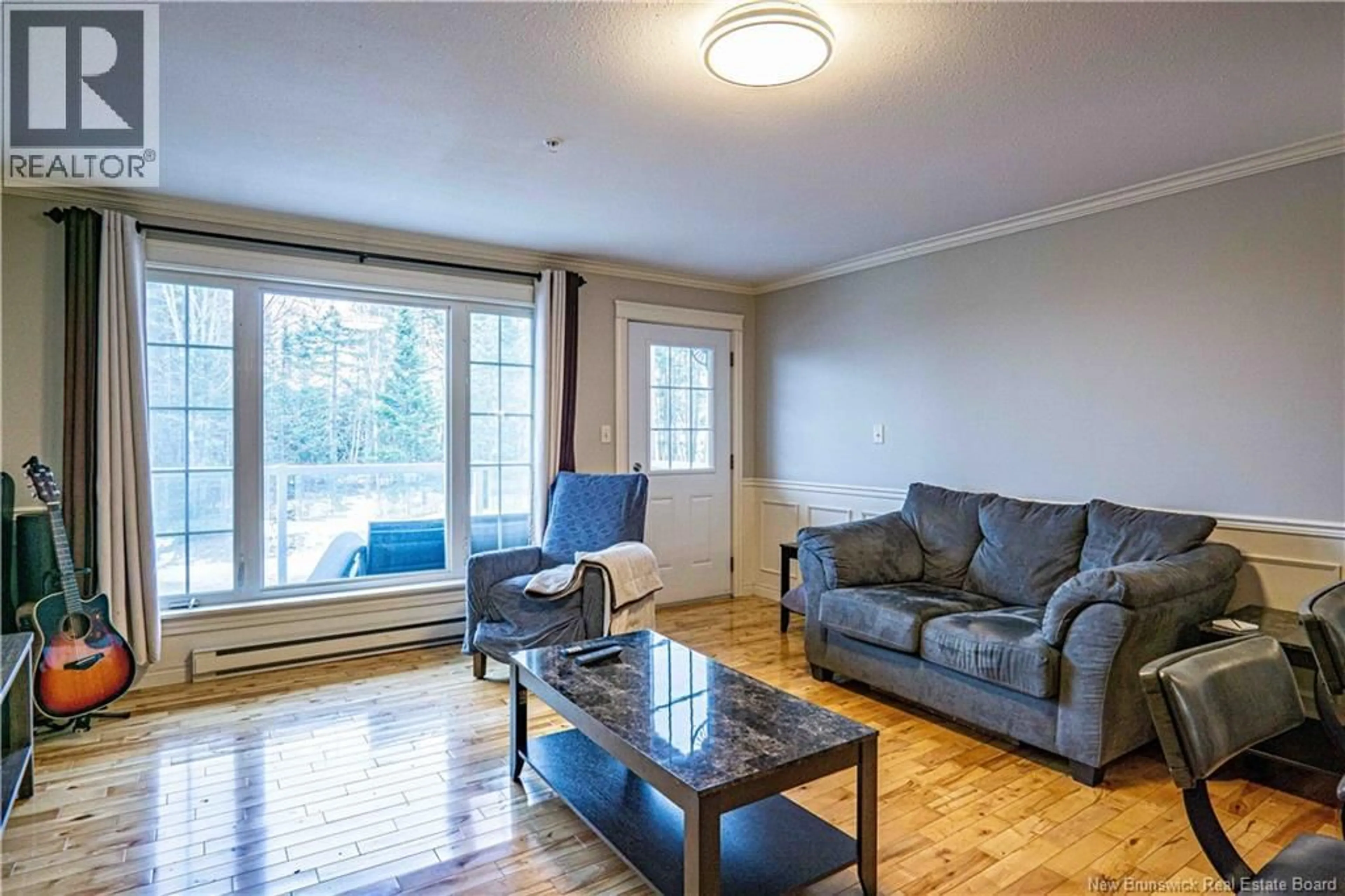 Living room with furniture, wood/laminate floor for 213 - 225 SERENITY LANE, Fredericton New Brunswick E3B0H1