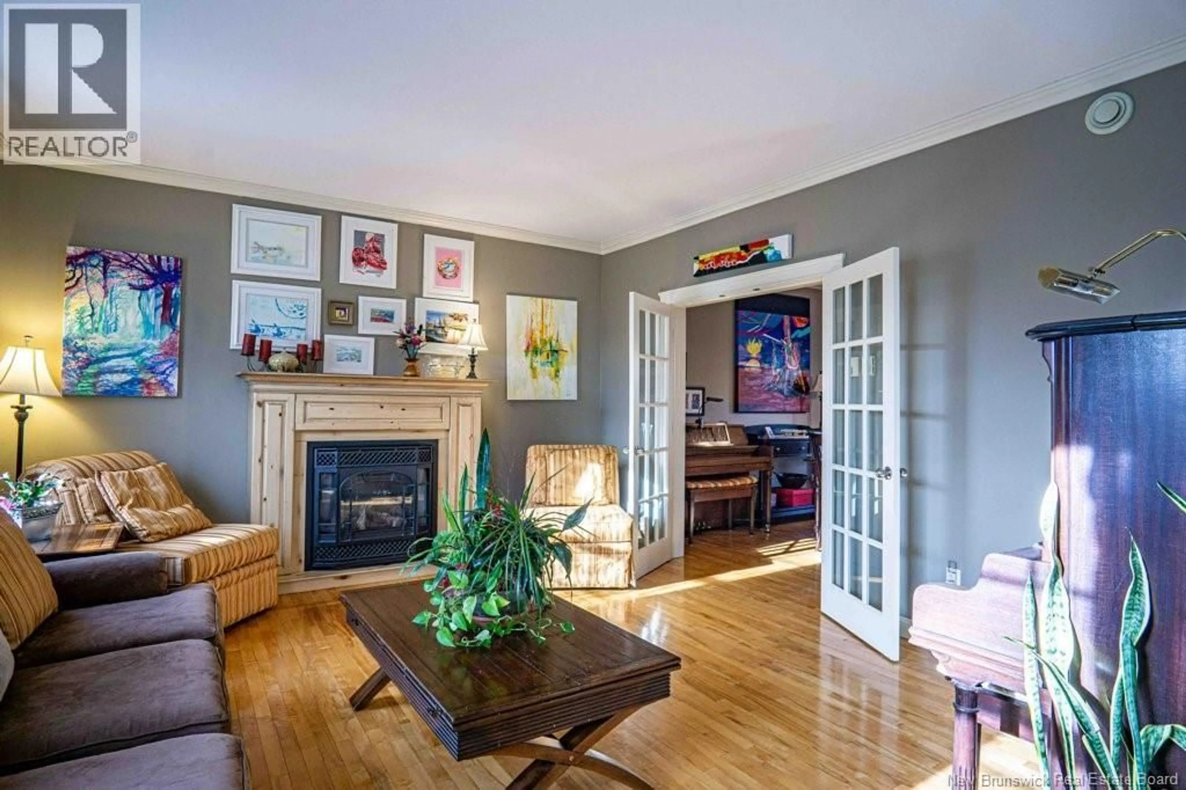 Living room with furniture, wood/laminate floor for 9 JENNIE COURT, Fredericton New Brunswick E3B9X9