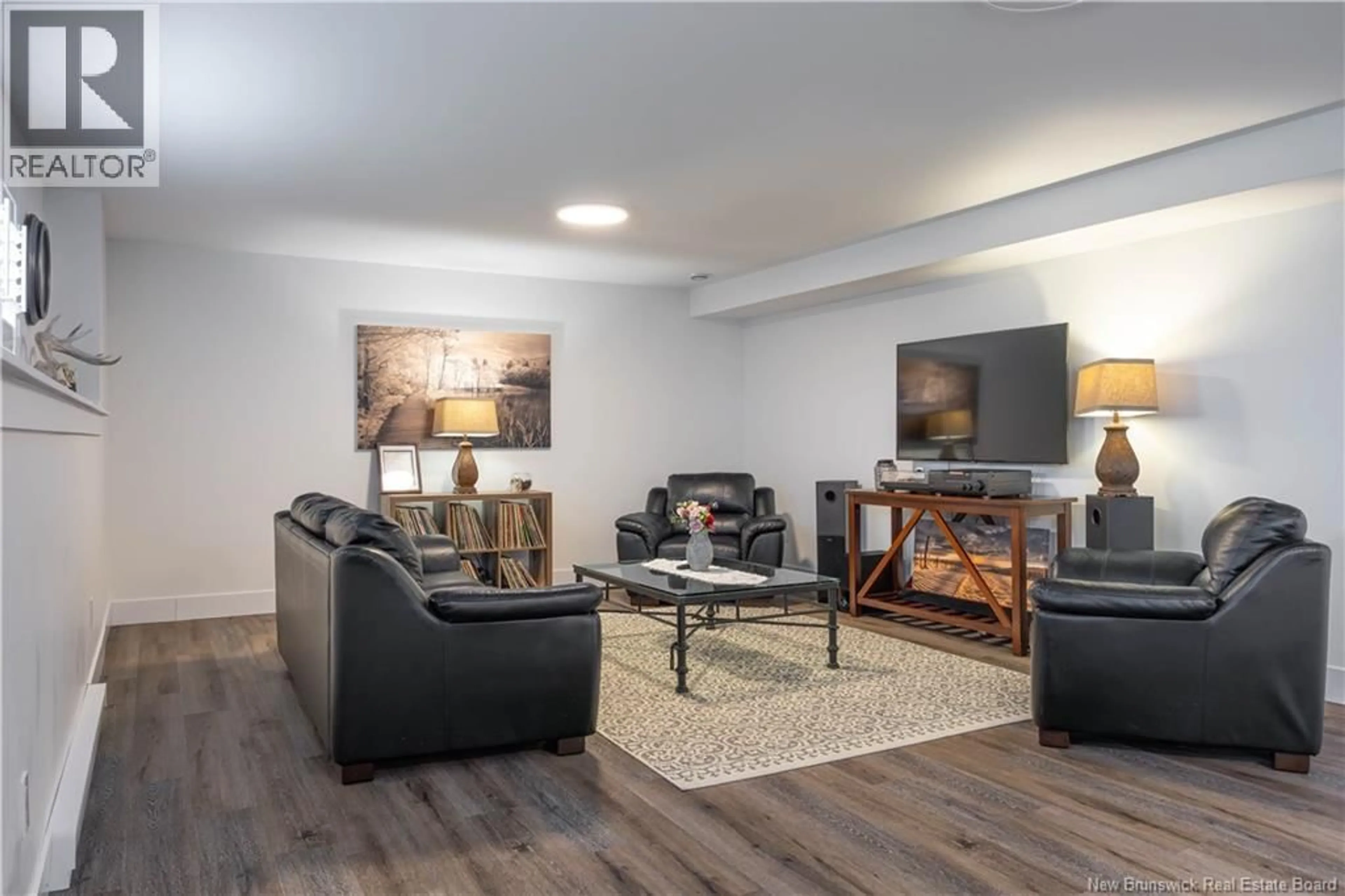 Living room with furniture, wood/laminate floor for 25 MERLIN DRIVE, Quispamsis New Brunswick E2E0Y3