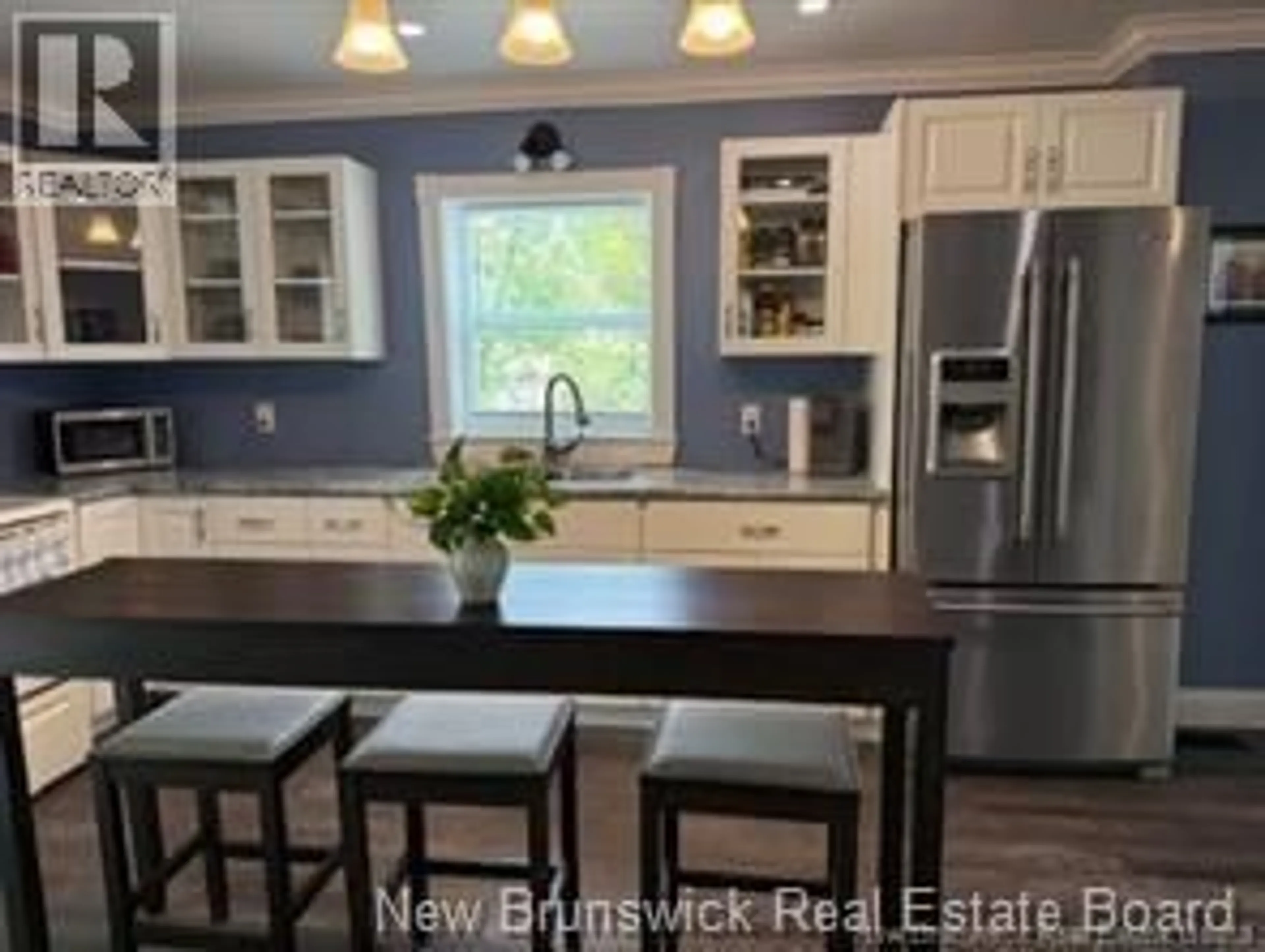 Open concept kitchen, wood/laminate floor for 519 KING GEORGE HWY, Miramichi New Brunswick E1V1M9