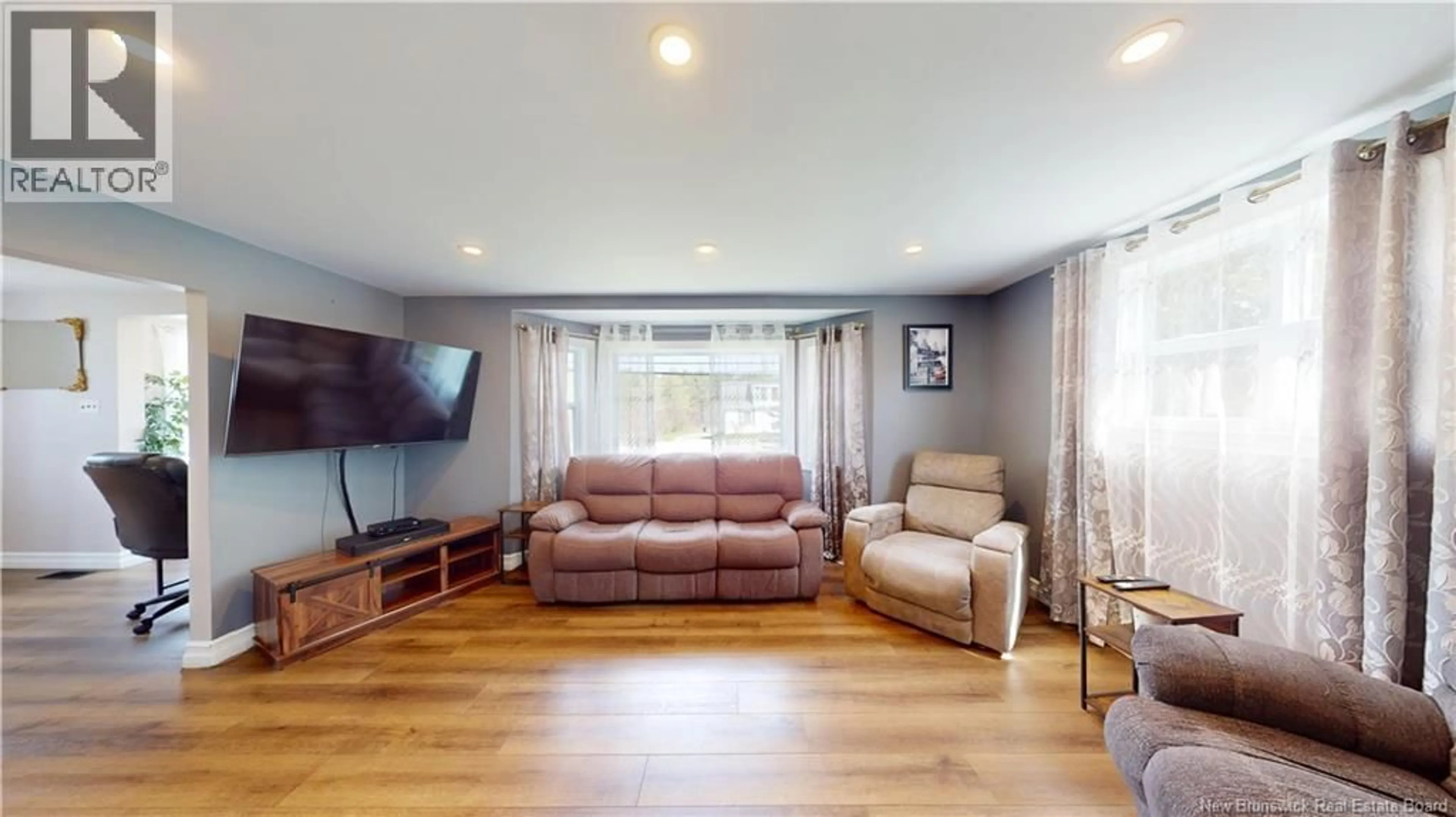 Living room with furniture, wood/laminate floor for 2394 LOCH LOMOND ROAD, Saint John New Brunswick E2N1A4