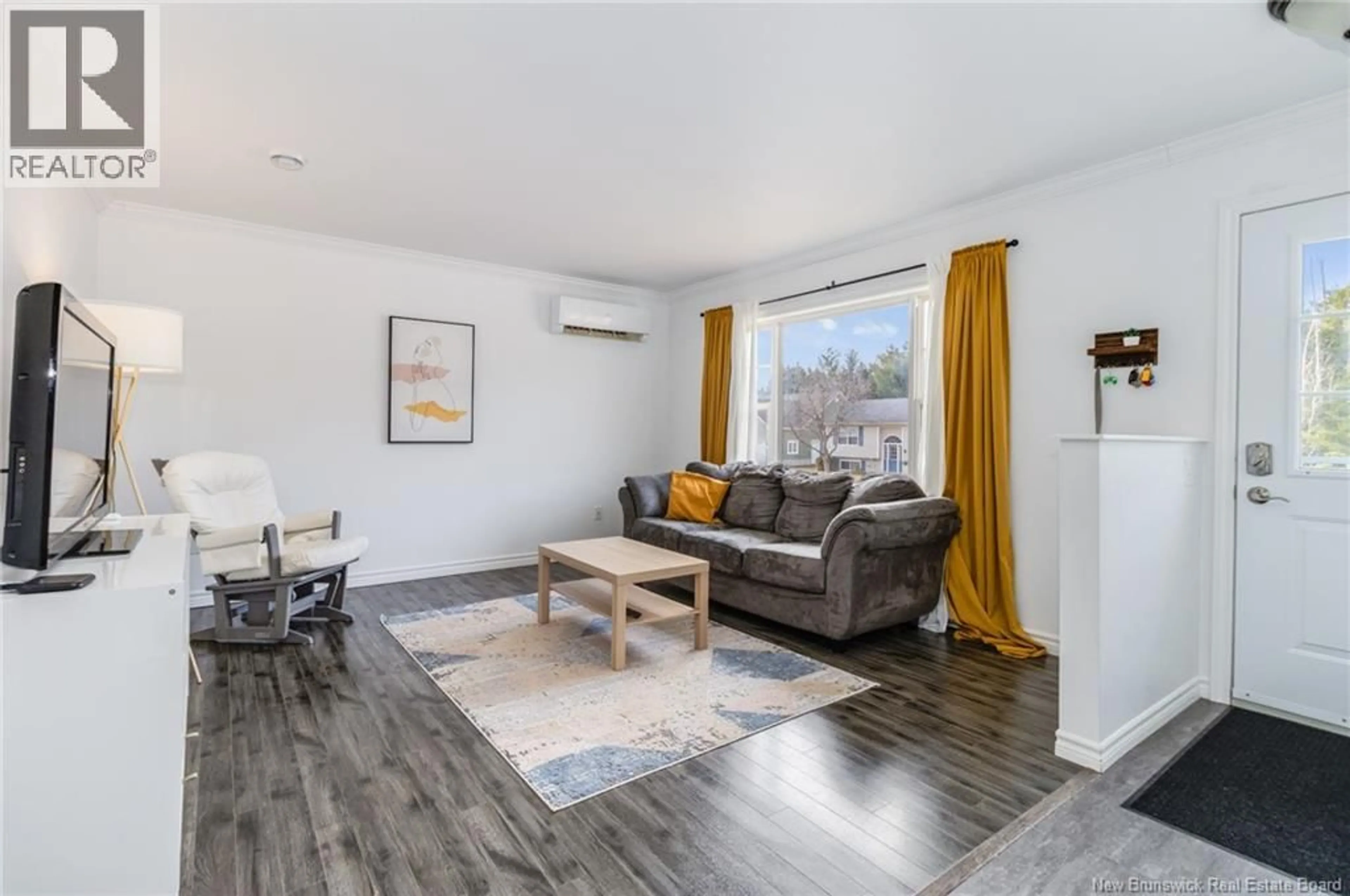 Living room with furniture, wood/laminate floor for 111 FINNAMORE STREET, Oromocto New Brunswick E2V2R5