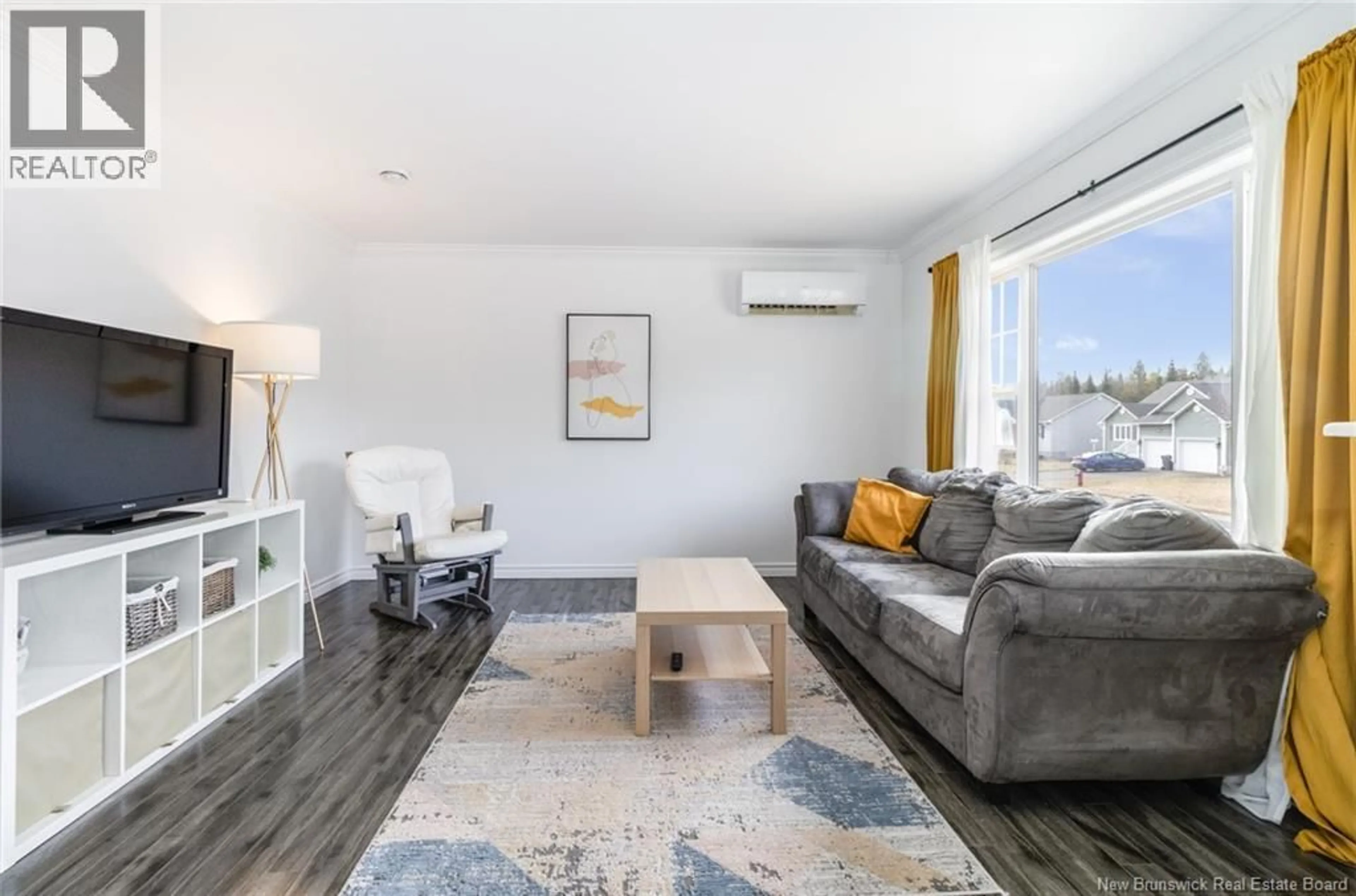 Living room with furniture, wood/laminate floor for 111 FINNAMORE STREET, Oromocto New Brunswick E2V2R5