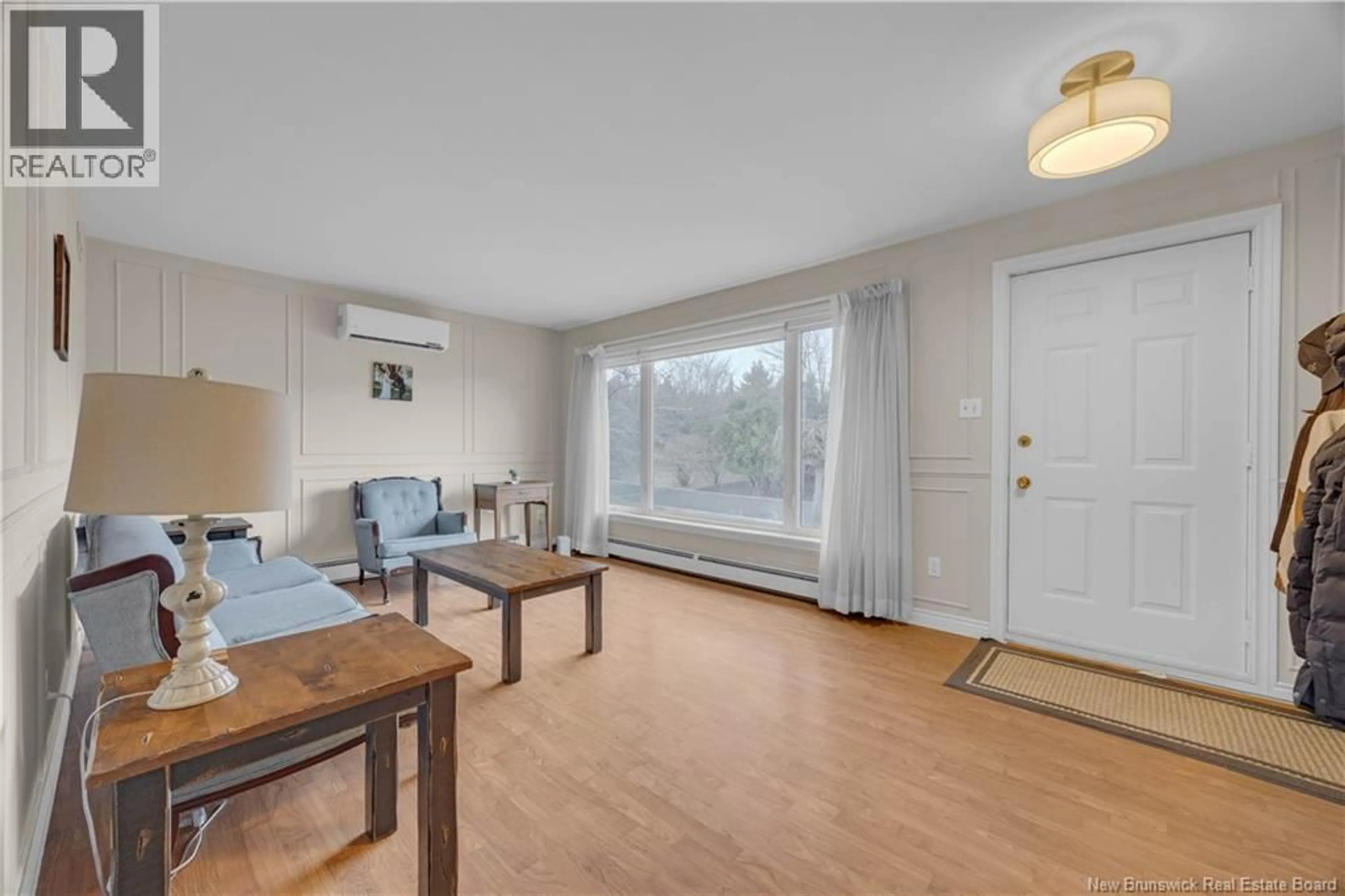 Living room with furniture, wood/laminate floor for 18 WESTMINSTER DRIVE, Quispamsis New Brunswick E2E2V3