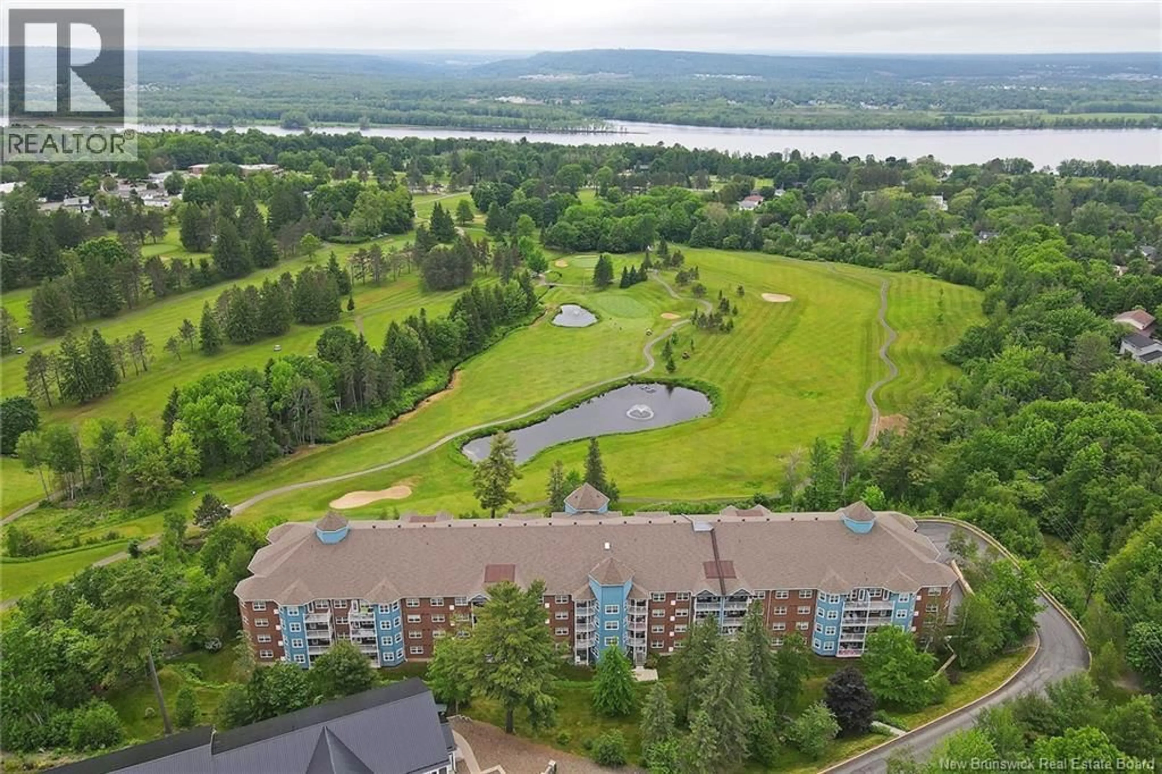 A pic from outside/outdoor area/front of a property/back of a property/a pic from drone, water/lake/river/ocean view for 409 - 1 GOLF GREENS LANE, Fredericton New Brunswick E3B9T9