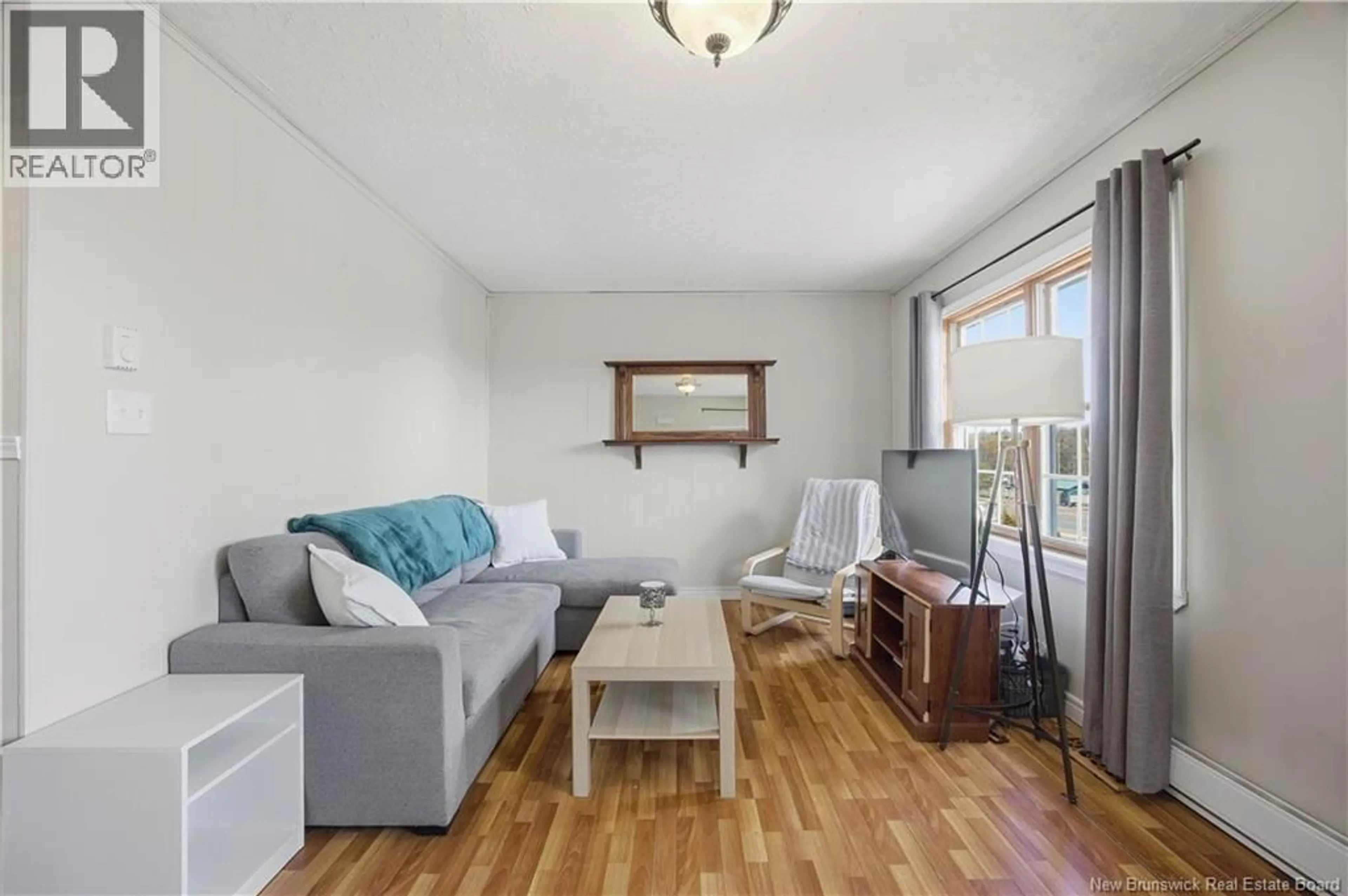 Living room with furniture, wood/laminate floor for 557 RIVER VALLEY DRIVE, Grand Bay-Westfield New Brunswick E5K1B2