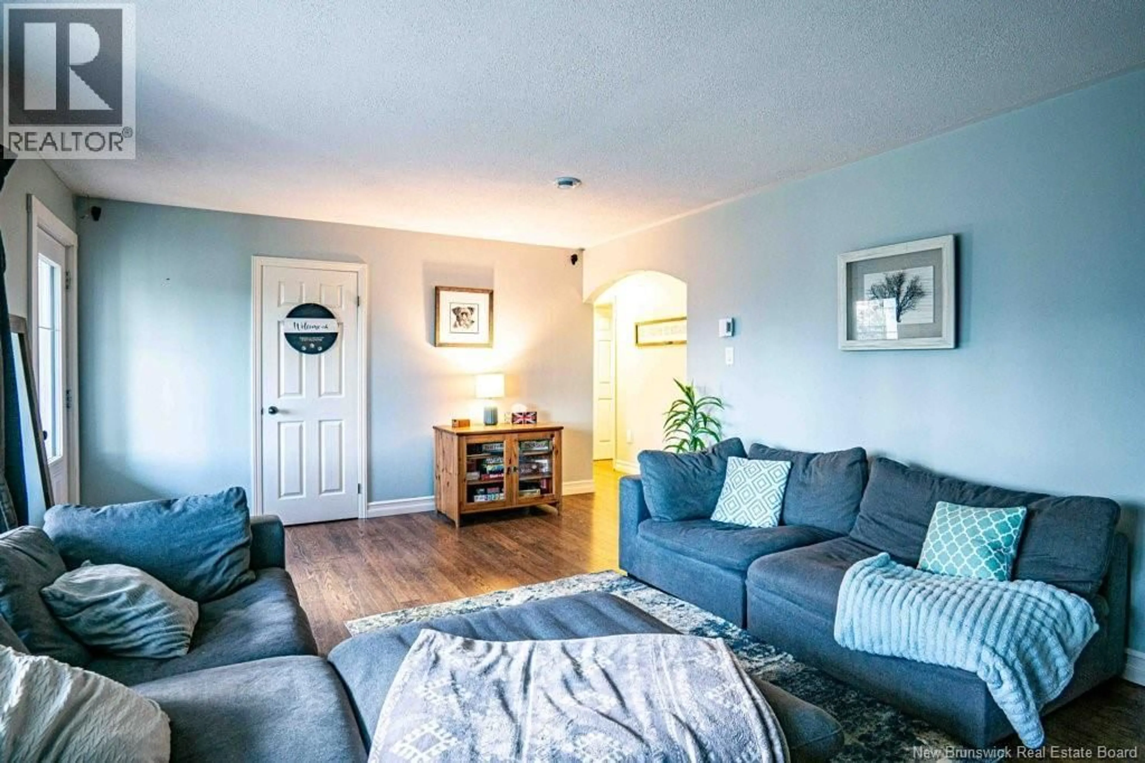 Living room with furniture, wood/laminate floor for 18 HILLSLEIGH COURT, Douglas New Brunswick E3G7Y9