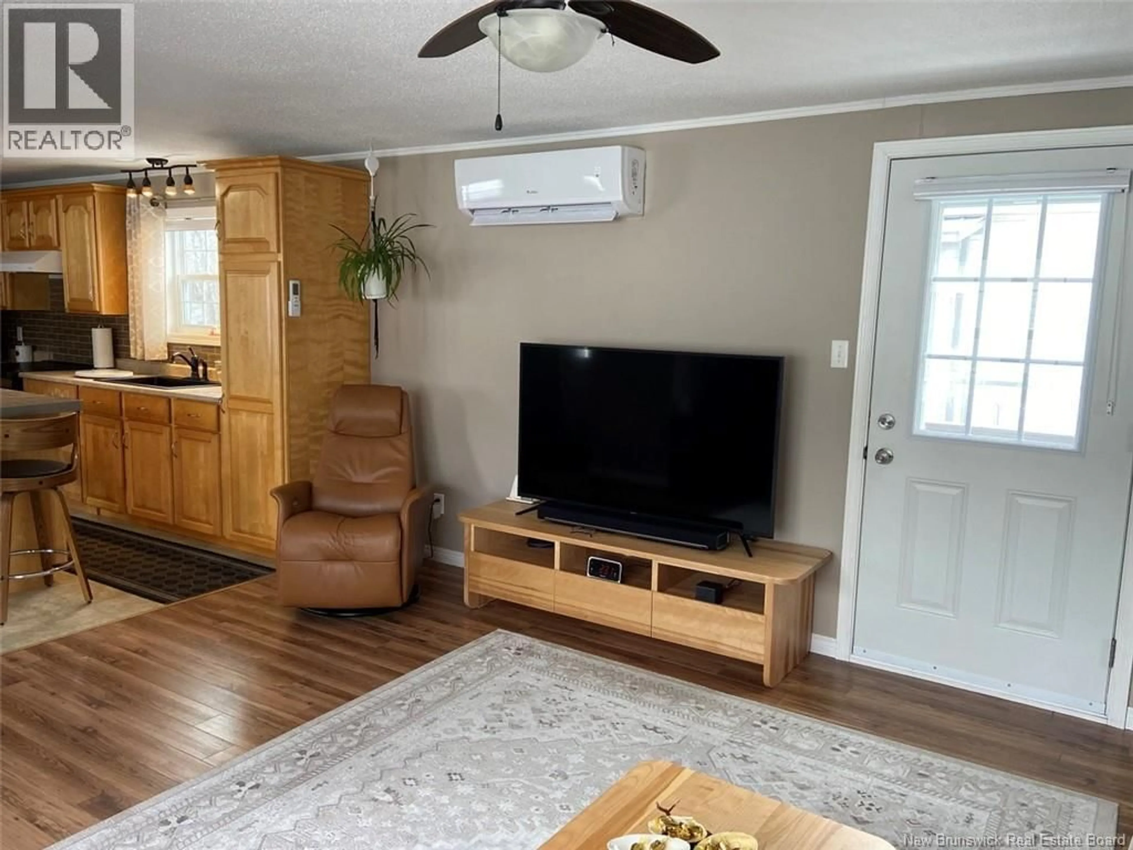 Living room with furniture, wood/laminate floor for 45 ALBERT ROAD, Saint-Jacques New Brunswick E7B1Z6