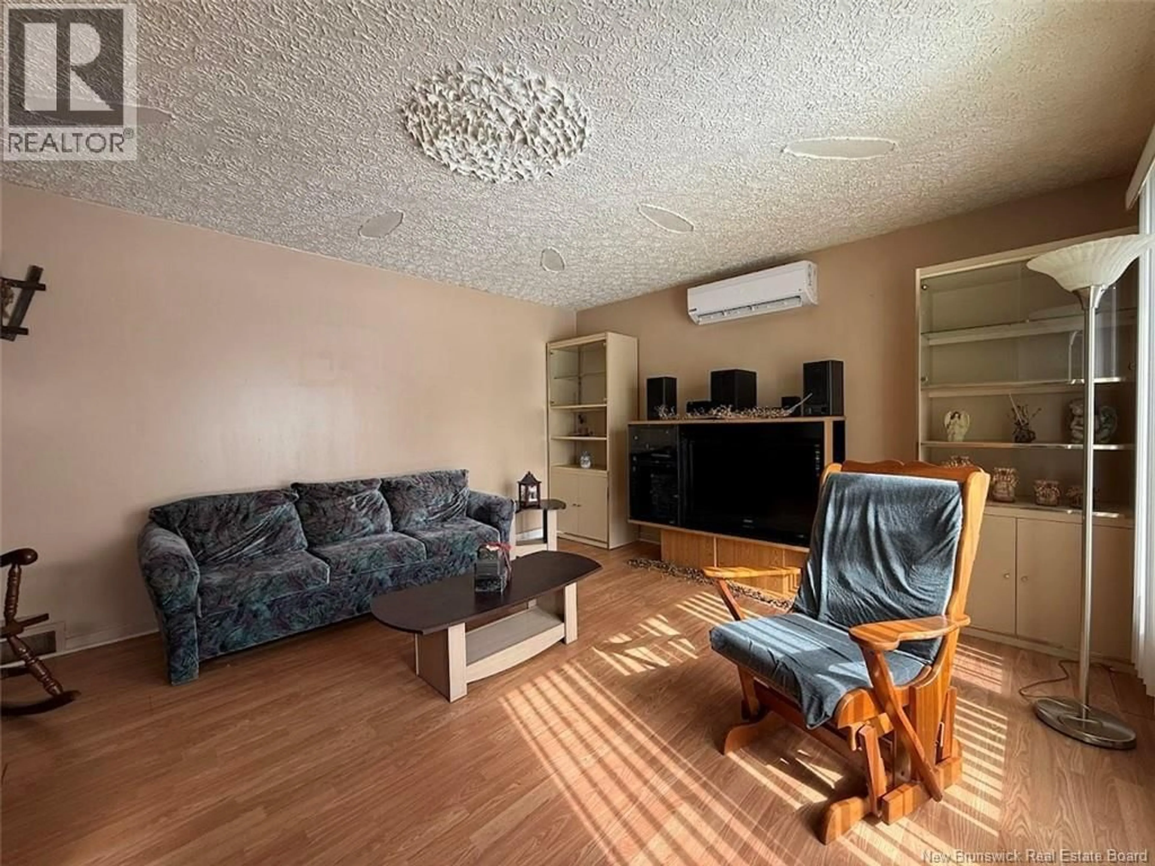 Living room with furniture, wood/laminate floor for 52 47TH AVENUE, Edmundston New Brunswick E3V3C2