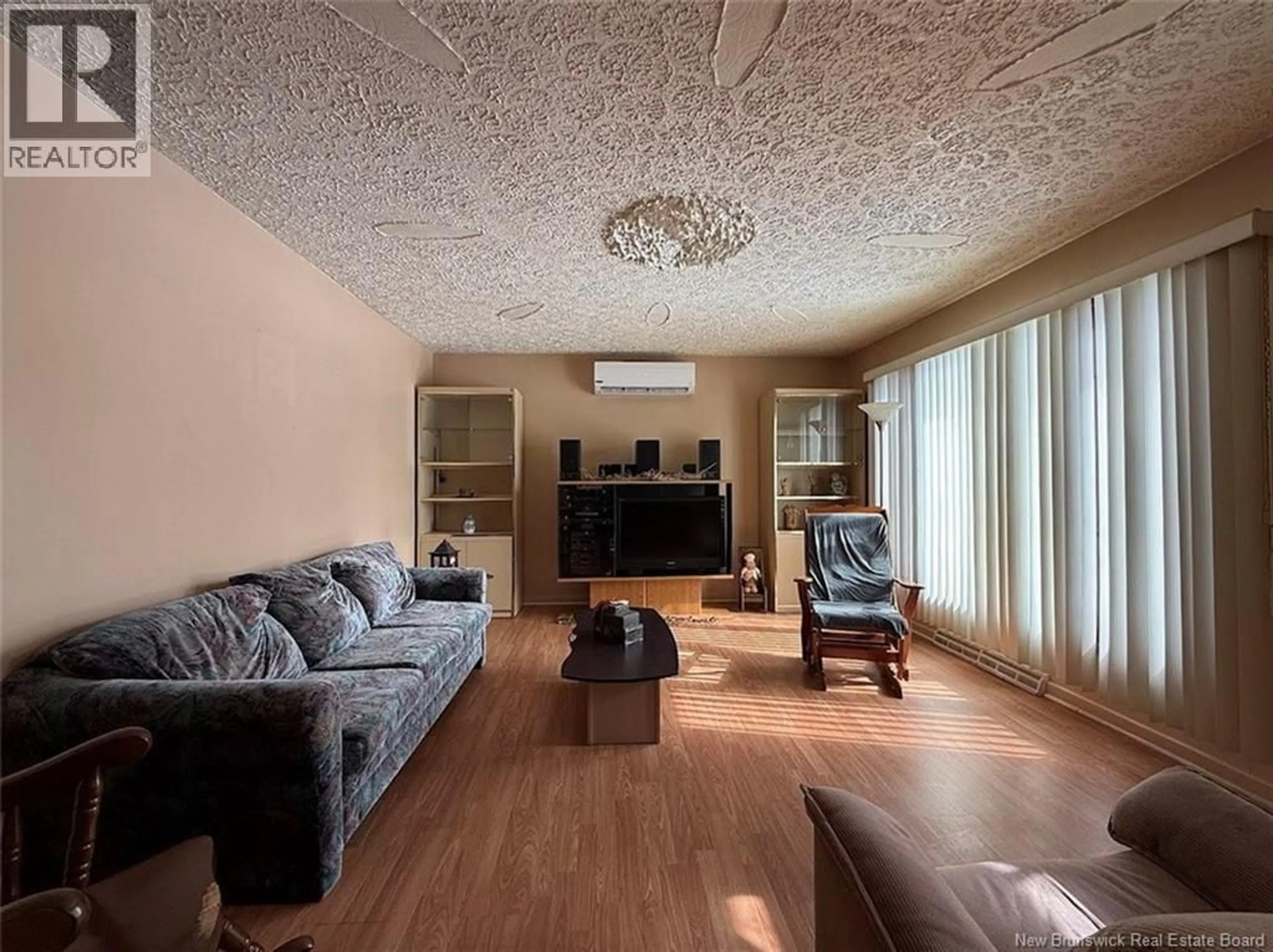 Living room with furniture, wood/laminate floor for 52 47TH AVENUE, Edmundston New Brunswick E3V3C2