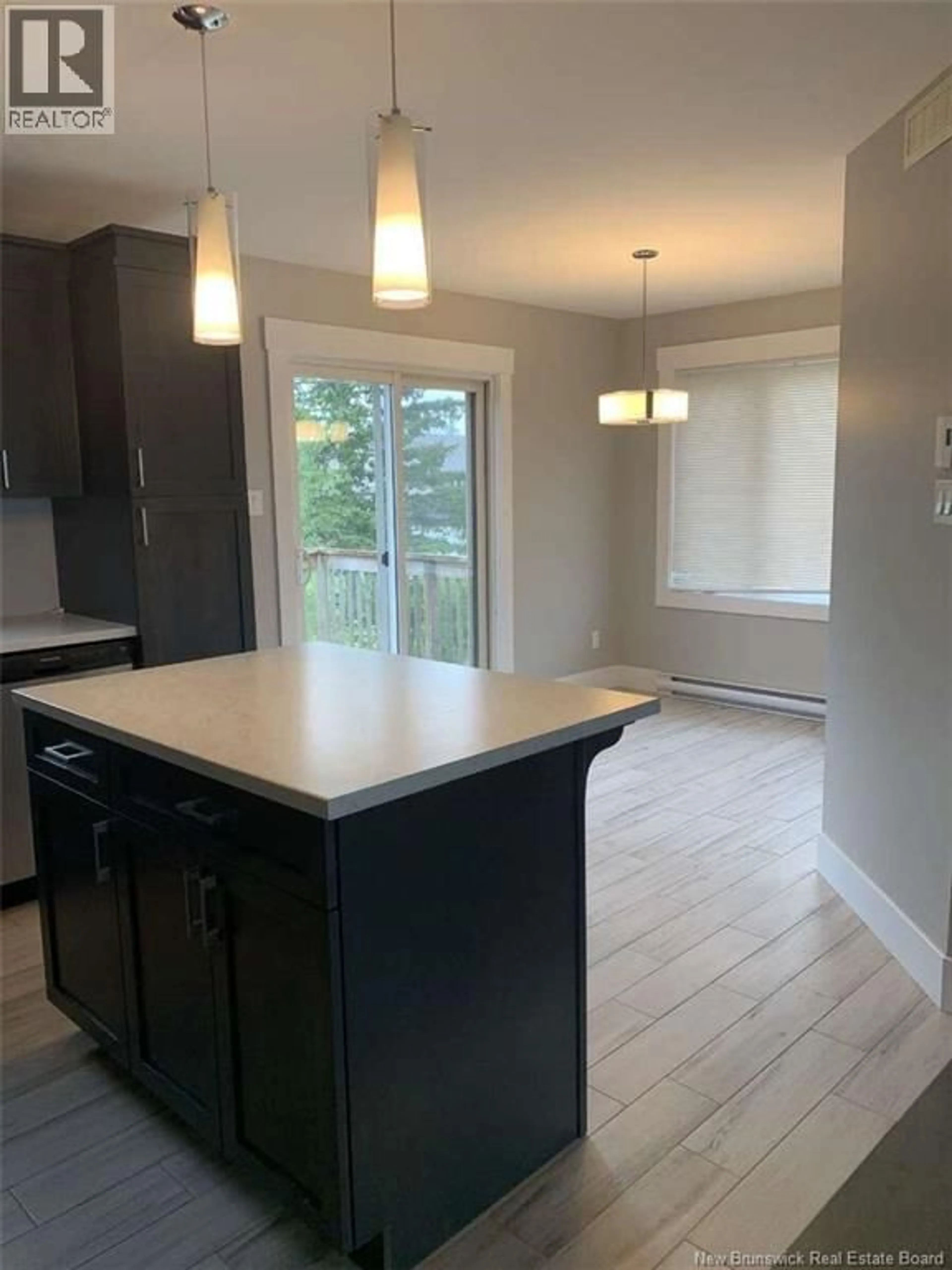 Open concept kitchen, wood/laminate floor for 98 LANCEFIELD CRESCENT, Moncton New Brunswick E1E0E6