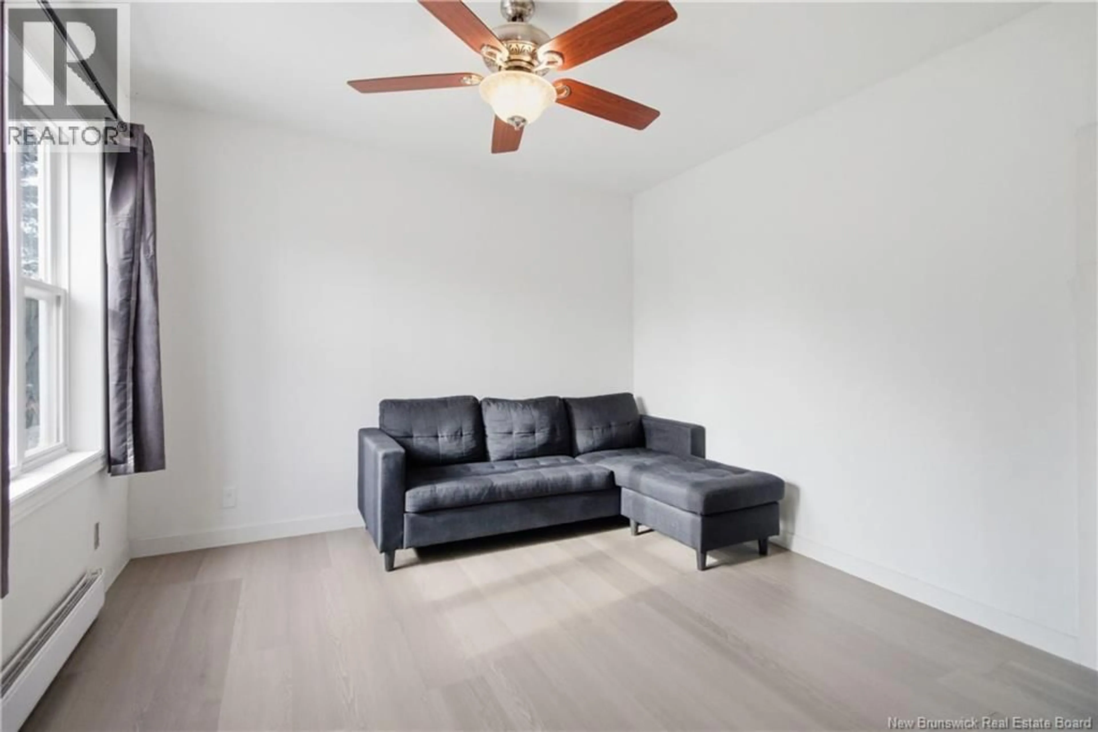 Living room with furniture, wood/laminate floor for 219 CHURCHILL STREET, Moncton New Brunswick E1C7J8