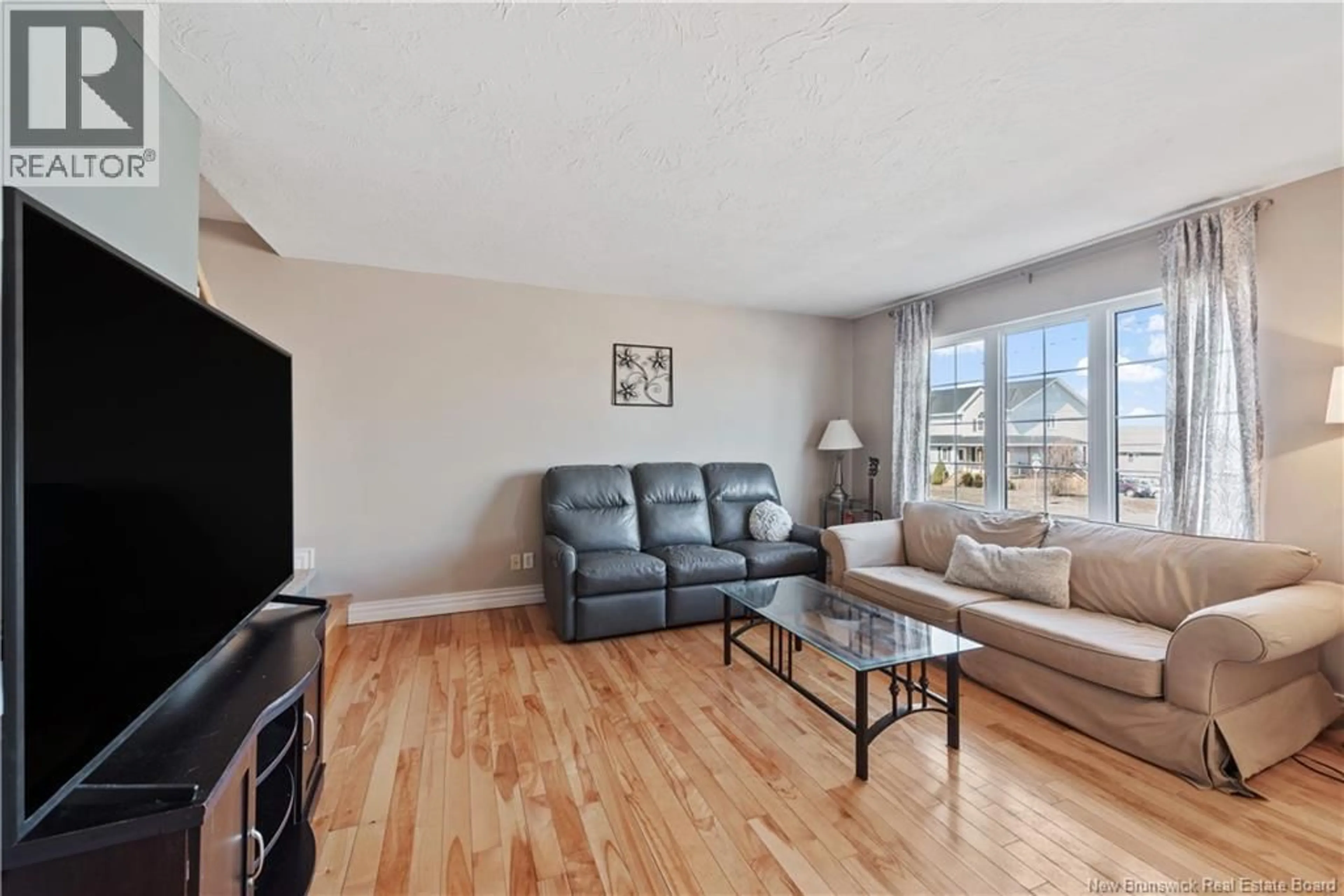 Living room with furniture, wood/laminate floor for 83 SAWGRASS DRIVE, Riverview New Brunswick E1B5E4