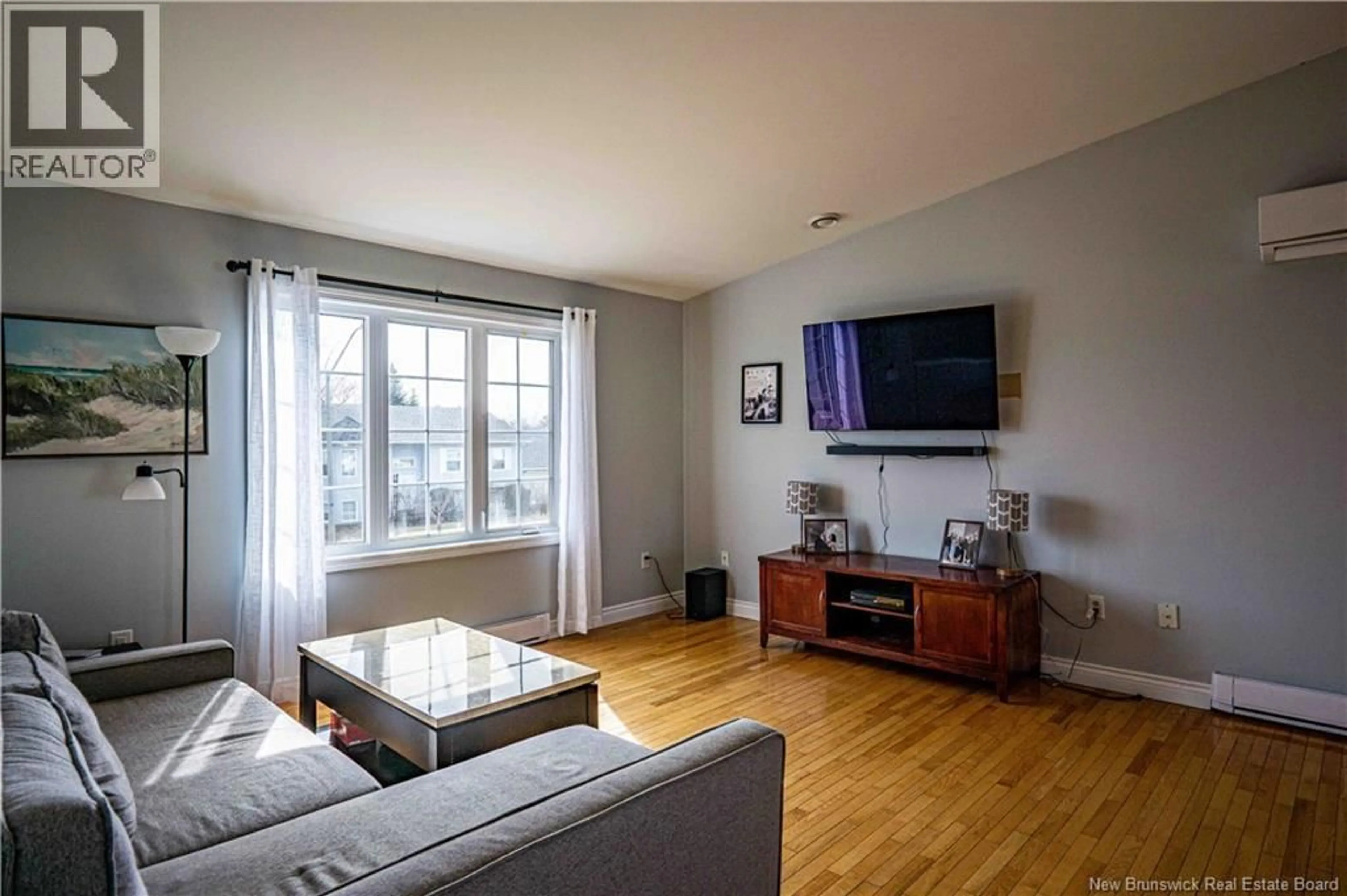 Living room with furniture, wood/laminate floor for 39 RIPLEY STREET, Oromocto New Brunswick E2V4P9