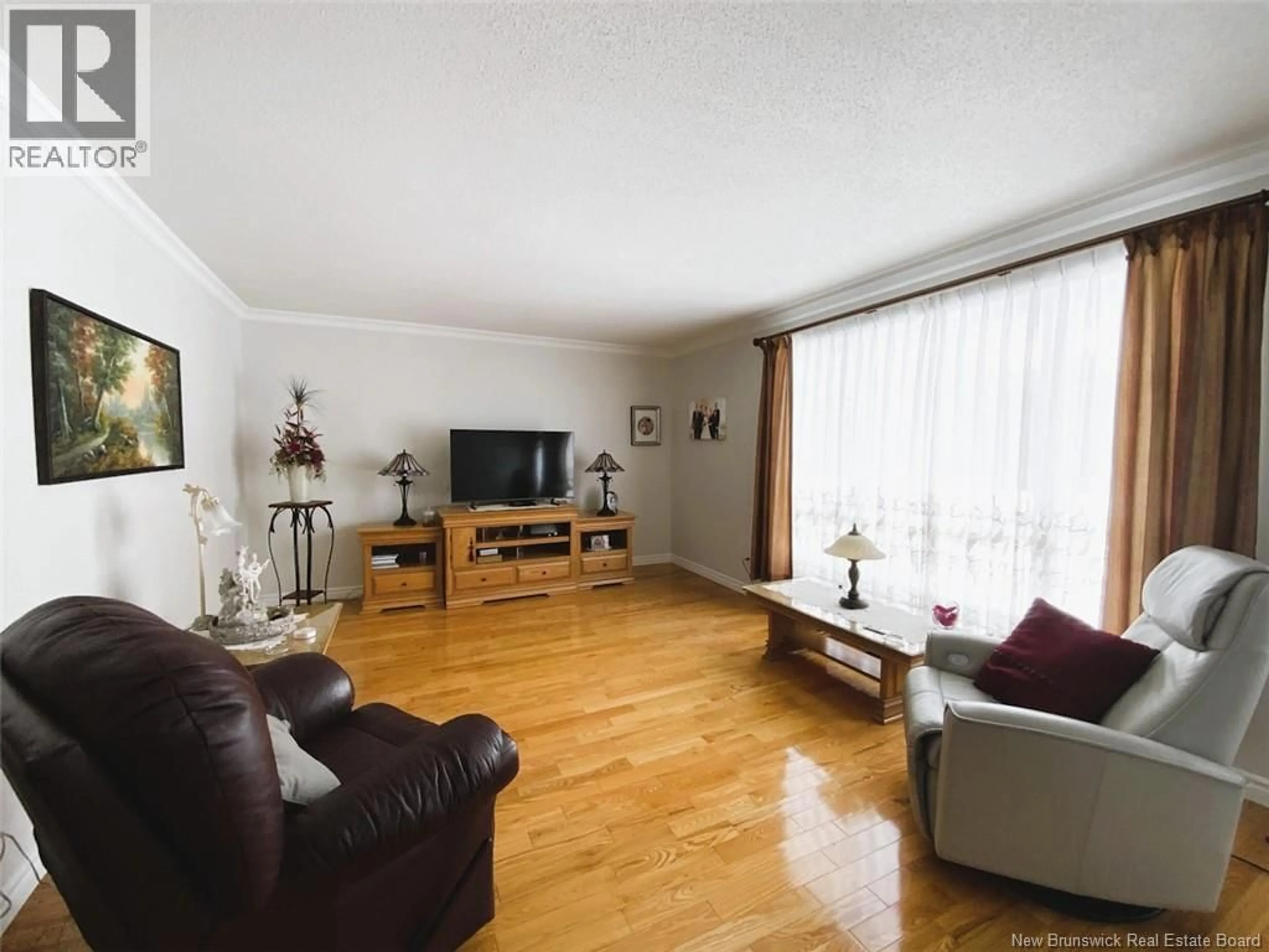 Living room with furniture, wood/laminate floor for 51 MADAWASKA STREET, Saint-Jacques New Brunswick E7B1L6