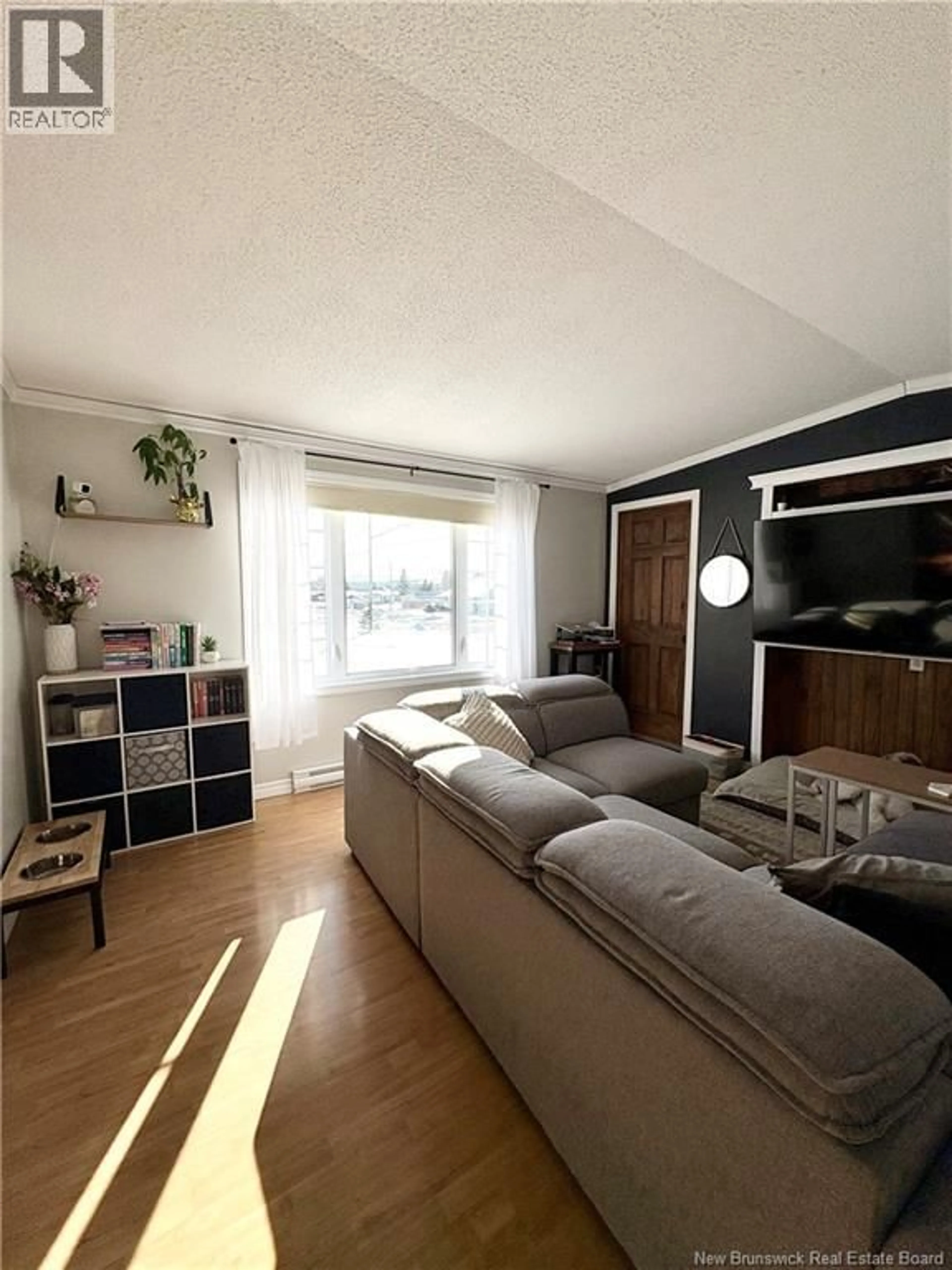 Living room with furniture, wood/laminate floor for 36 SOUCY STREET, Saint-Léonard New Brunswick E7E2V4