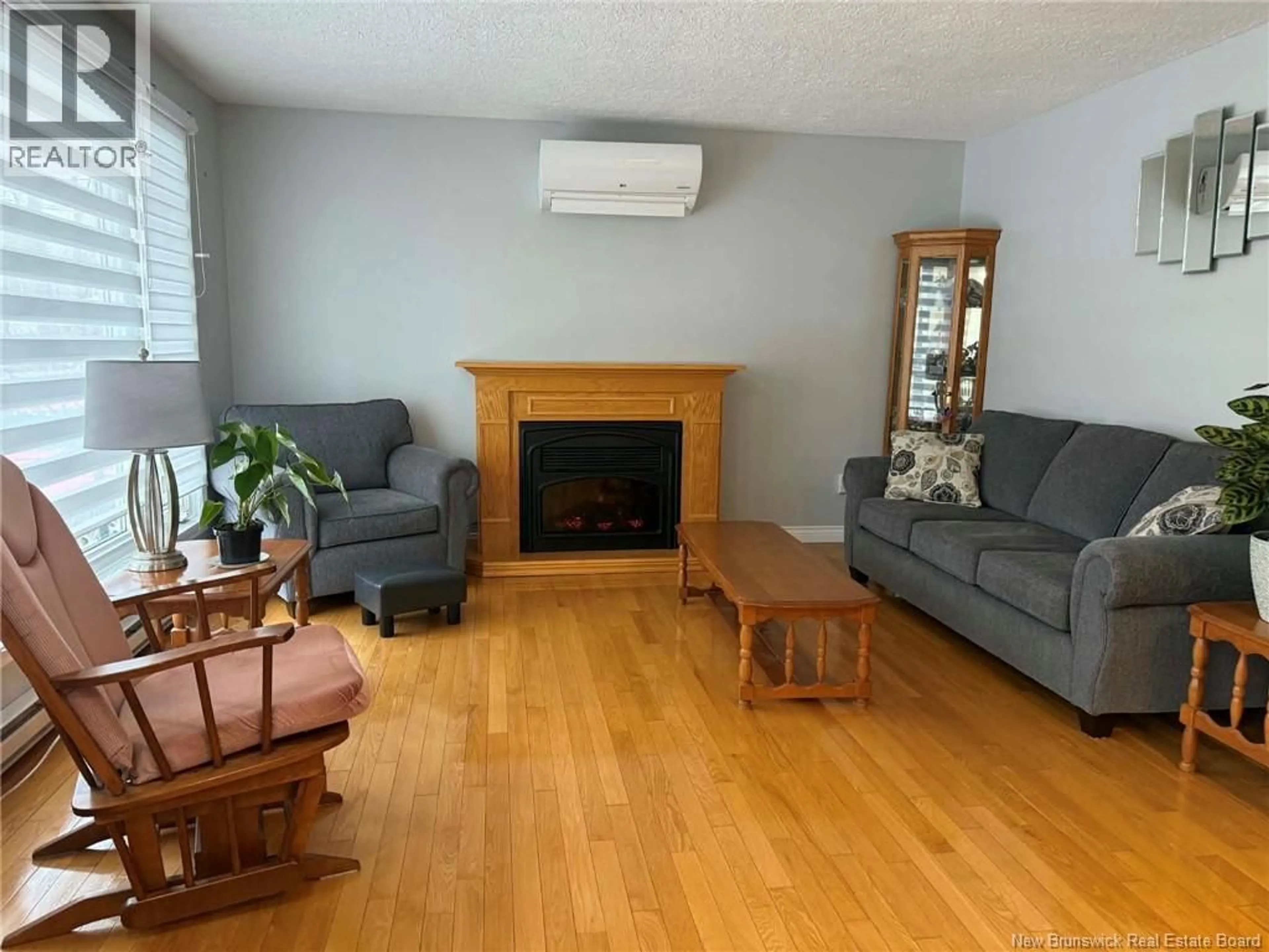 Living room with furniture, wood/laminate floor for 614 WILLISTON DRIVE, Miramichi New Brunswick E1V5X7