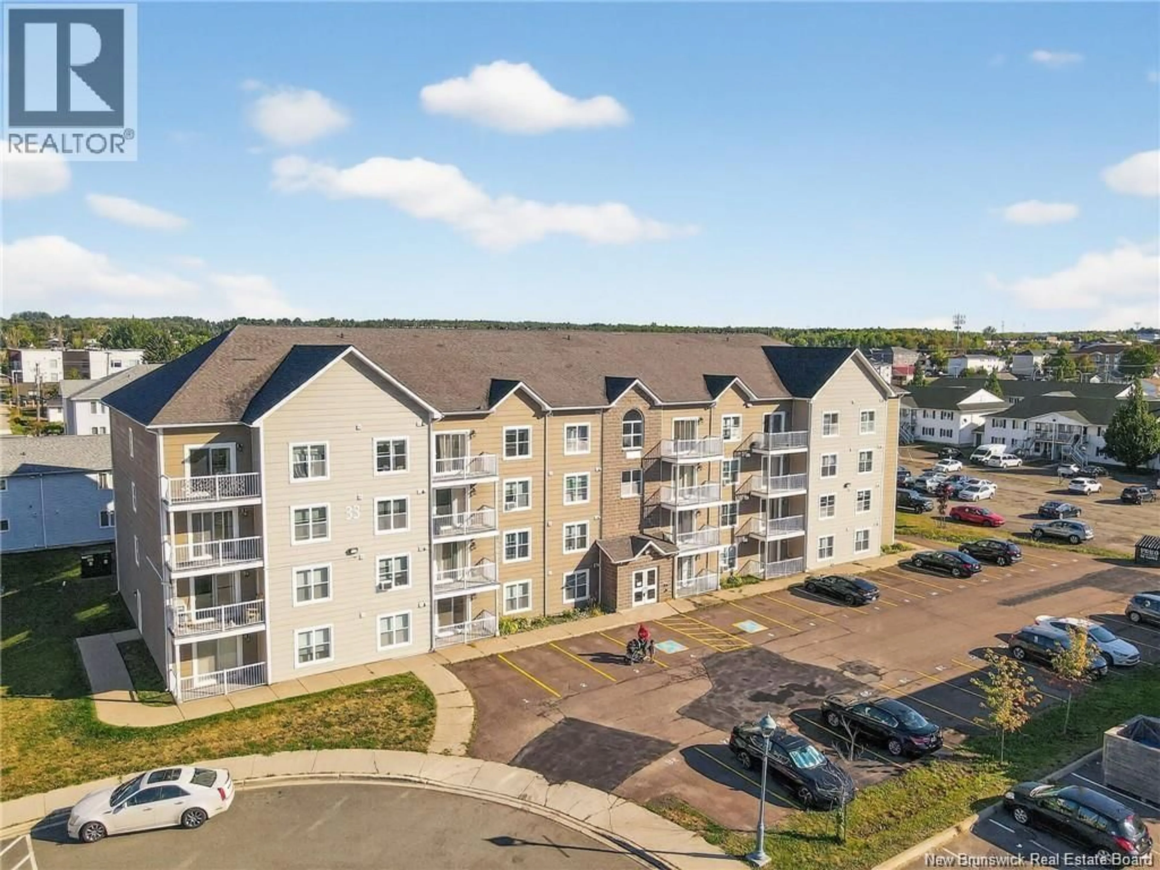 A pic from outside/outdoor area/front of a property/back of a property/a pic from drone, unknown for 407 - 33 SIFROI STREET, Dieppe New Brunswick E1A5T1