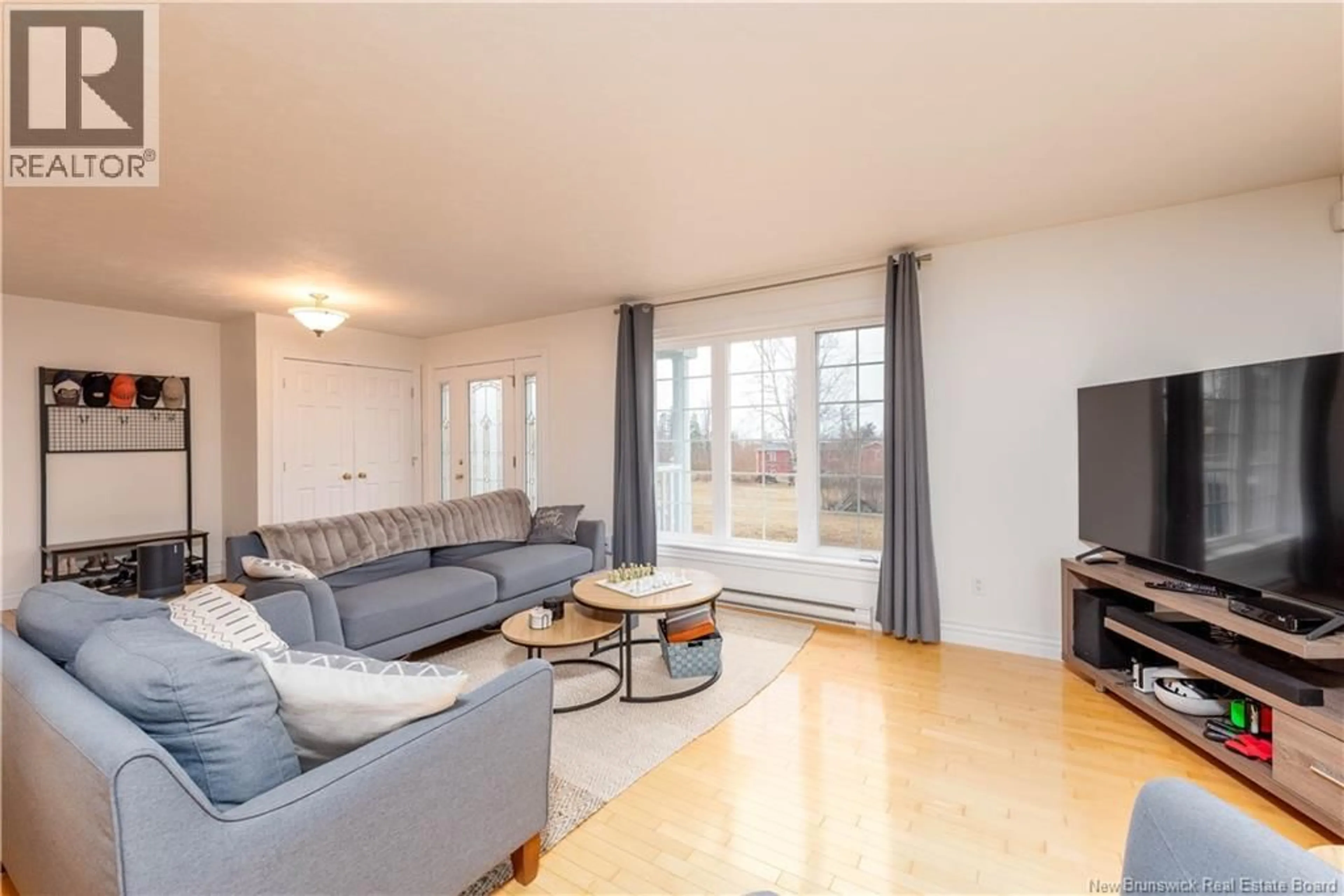 Living room with furniture, wood/laminate floor for 4 BEAU MATIN LANE, Grand-Barachois New Brunswick E4P6T8