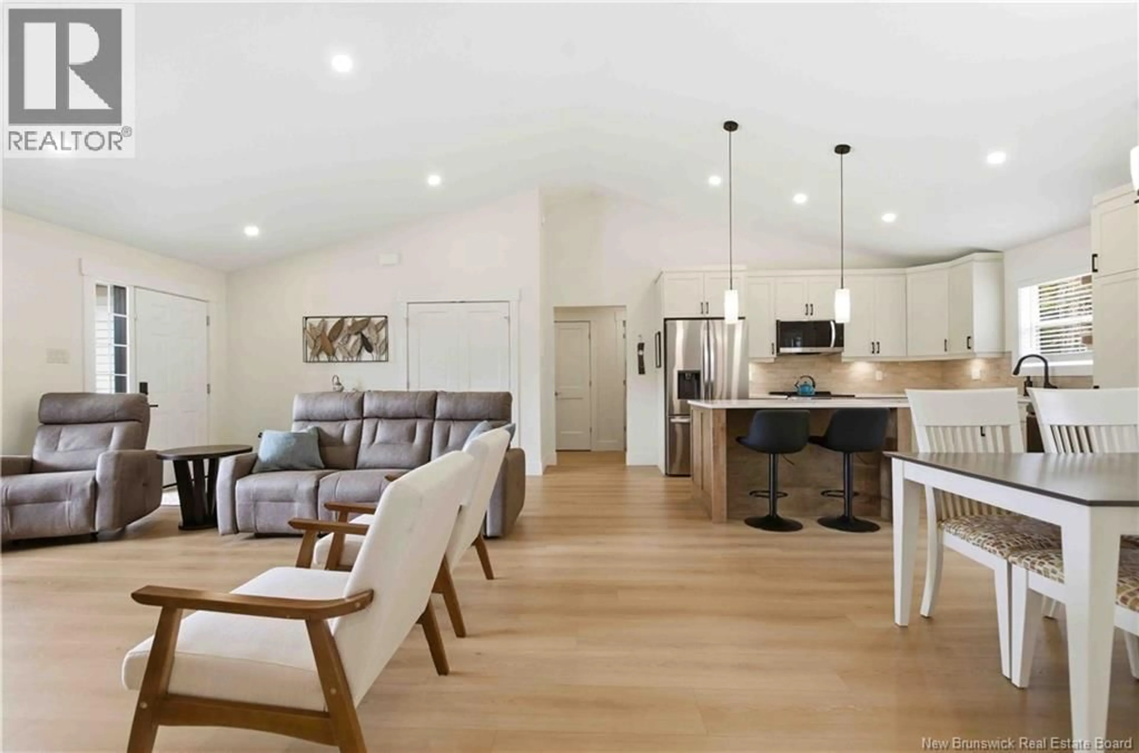 Open concept kitchen, wood/laminate floor for 24 SANDLEWOOD LANE, Douglas New Brunswick E3G9K7