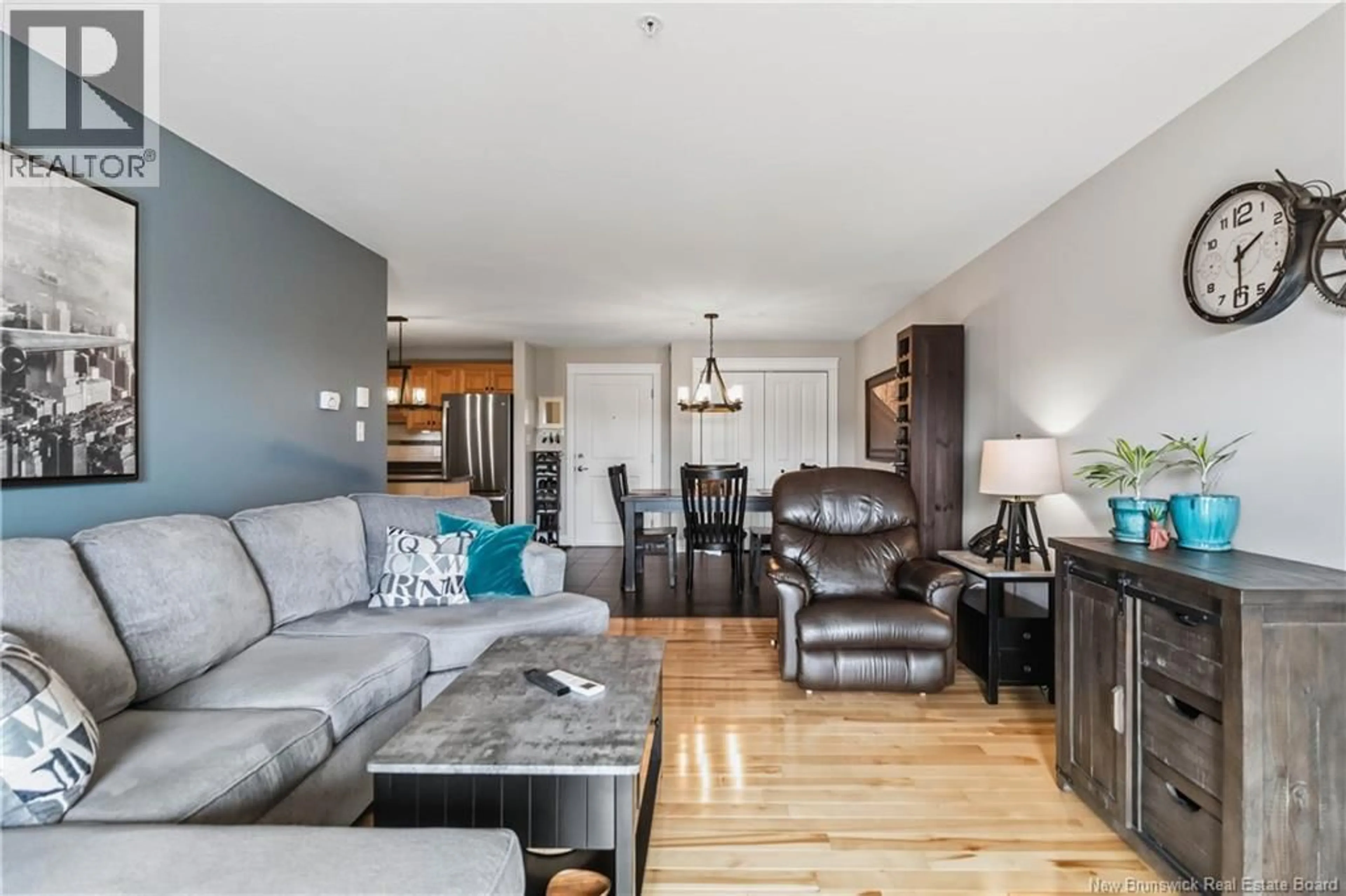 Living room with furniture, wood/laminate floor for 407 - 65 DIAMOND HEAD COURT, Moncton New Brunswick E1G0V6