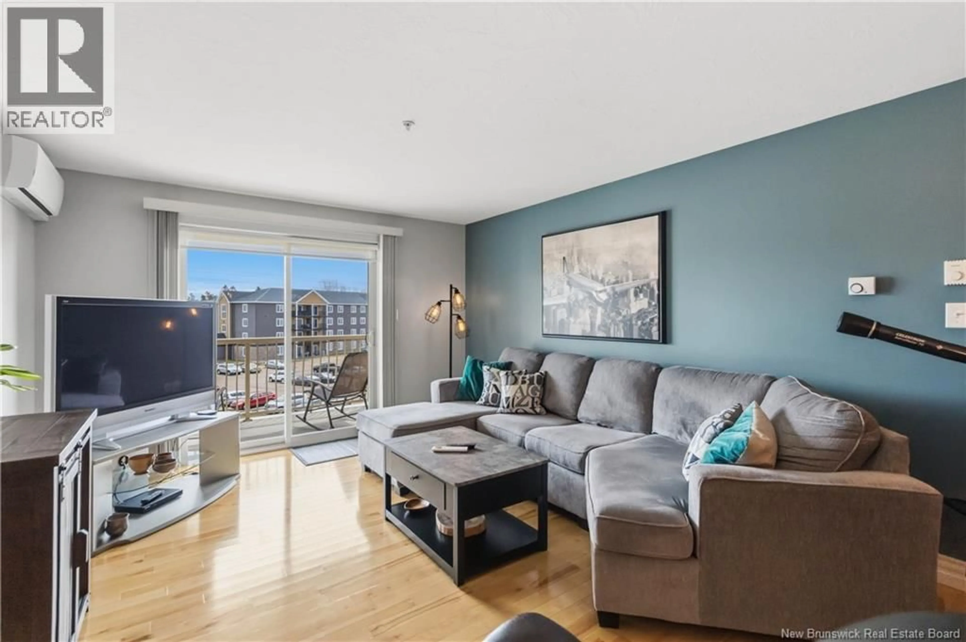 Living room with furniture, wood/laminate floor for 407 - 65 DIAMOND HEAD COURT, Moncton New Brunswick E1G0V6