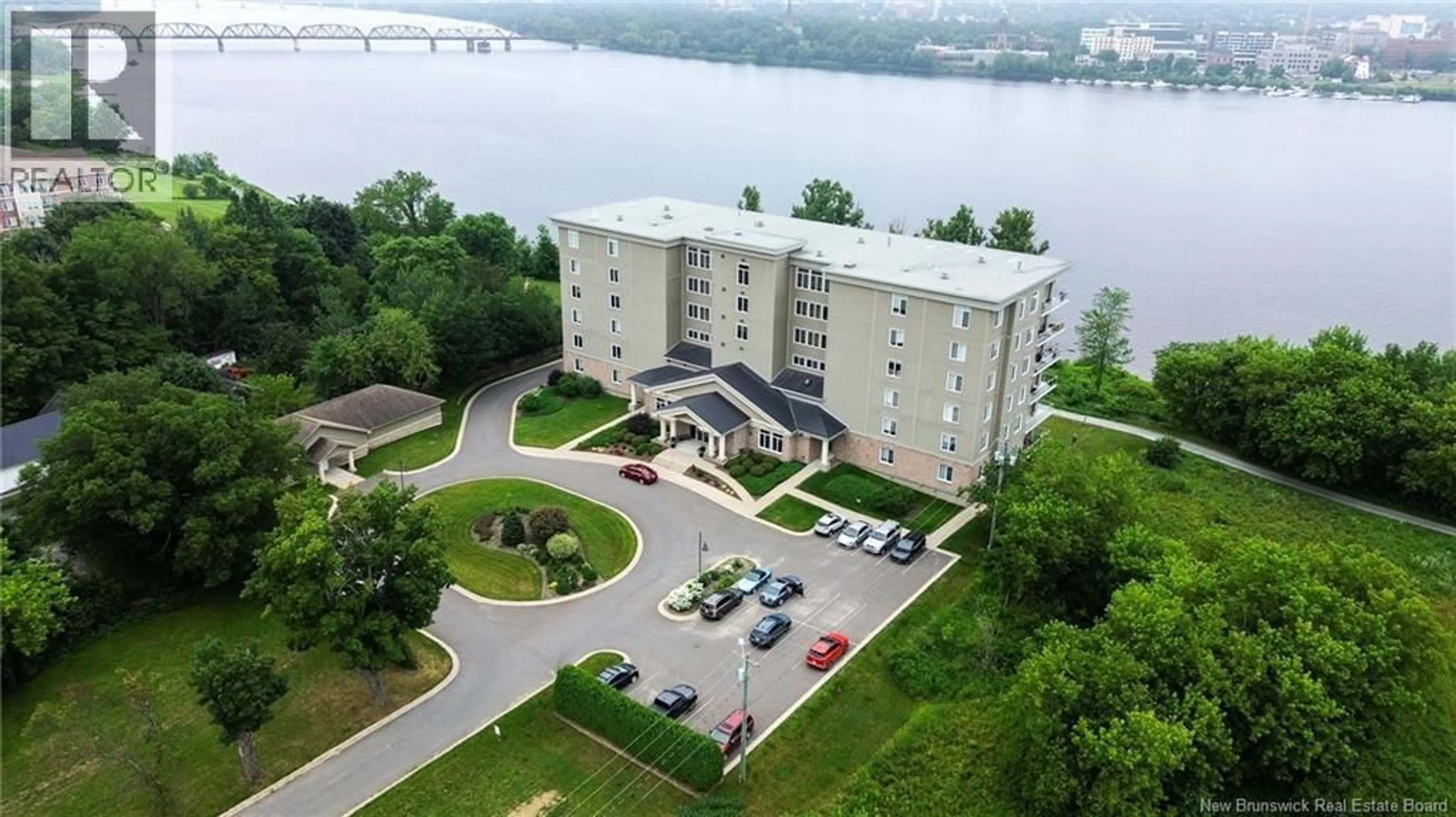 A pic from outside/outdoor area/front of a property/back of a property/a pic from drone, water/lake/river/ocean view for 505 - 1 SOUTHVIEW LANE LANE, Fredericton New Brunswick E3A5V3